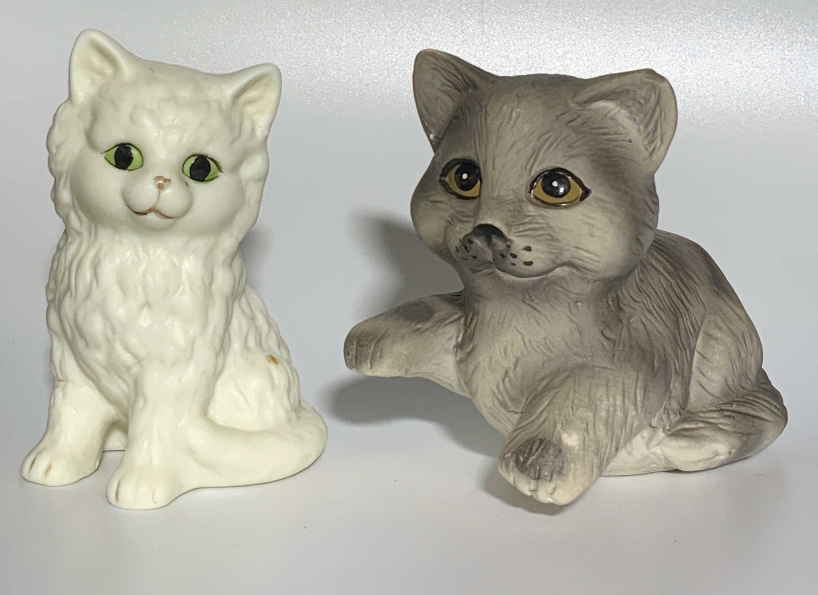 Vintage Porcelain Cat Pair Figurines: Vintage Porcelain Cat Pair Figurines, biggest measures 4 1/2 inches long x 2 1/2 inches wide x 4 inches tall. Property of Manhattan, NY Estate. Art, antique, antique tabletop art, antique tabletop acc