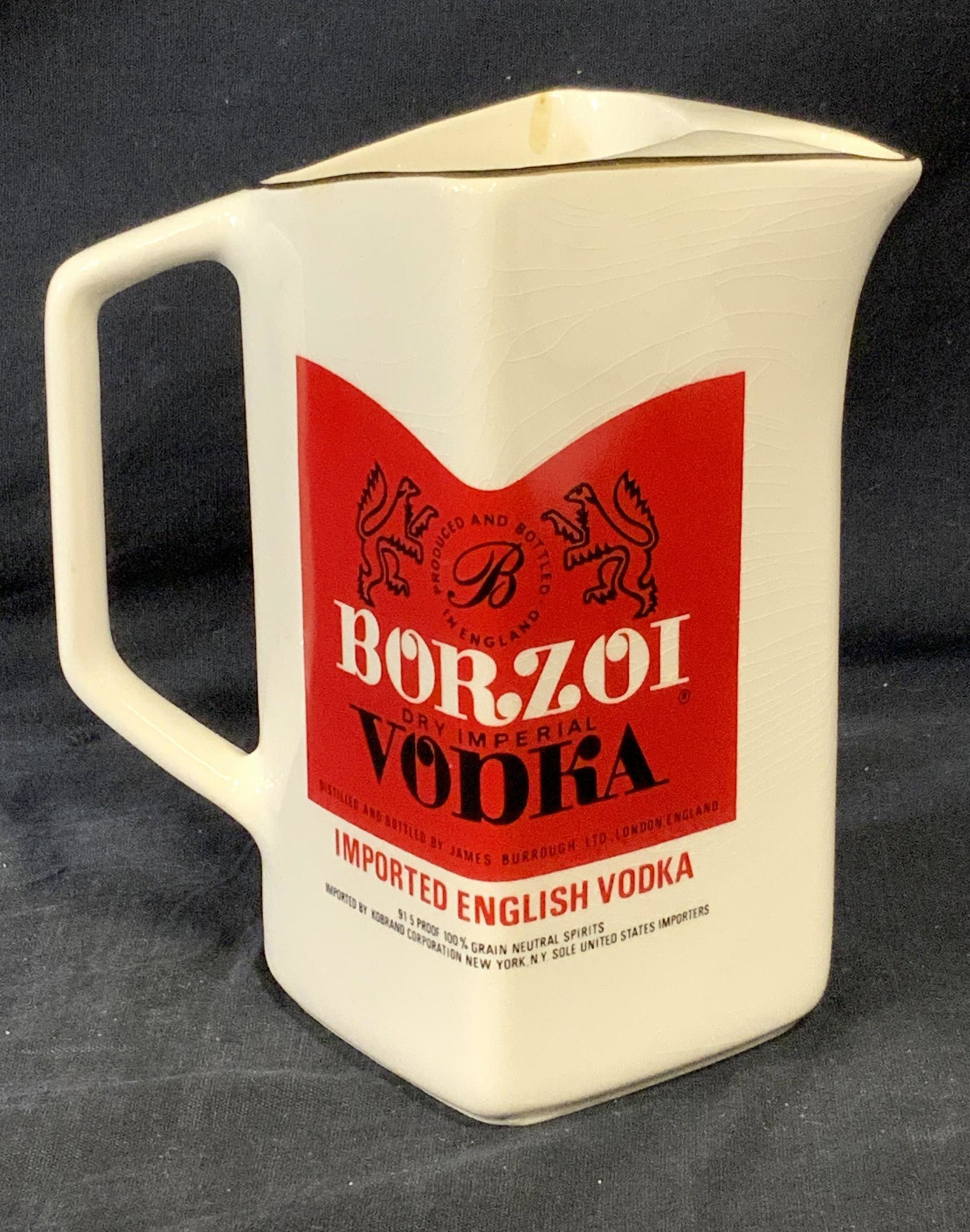 WADE ENGLAND Borzoi Vodka Vtg Porcelain Pitcher: WADE ENGLAND Borzoi Vodka Vtg Porcelain Pitcher, white porcelain pitcher with gilt brim, BORZOI VODKA branding, made in England, logo on either side of pitcher, wear consistent with age and use, measu