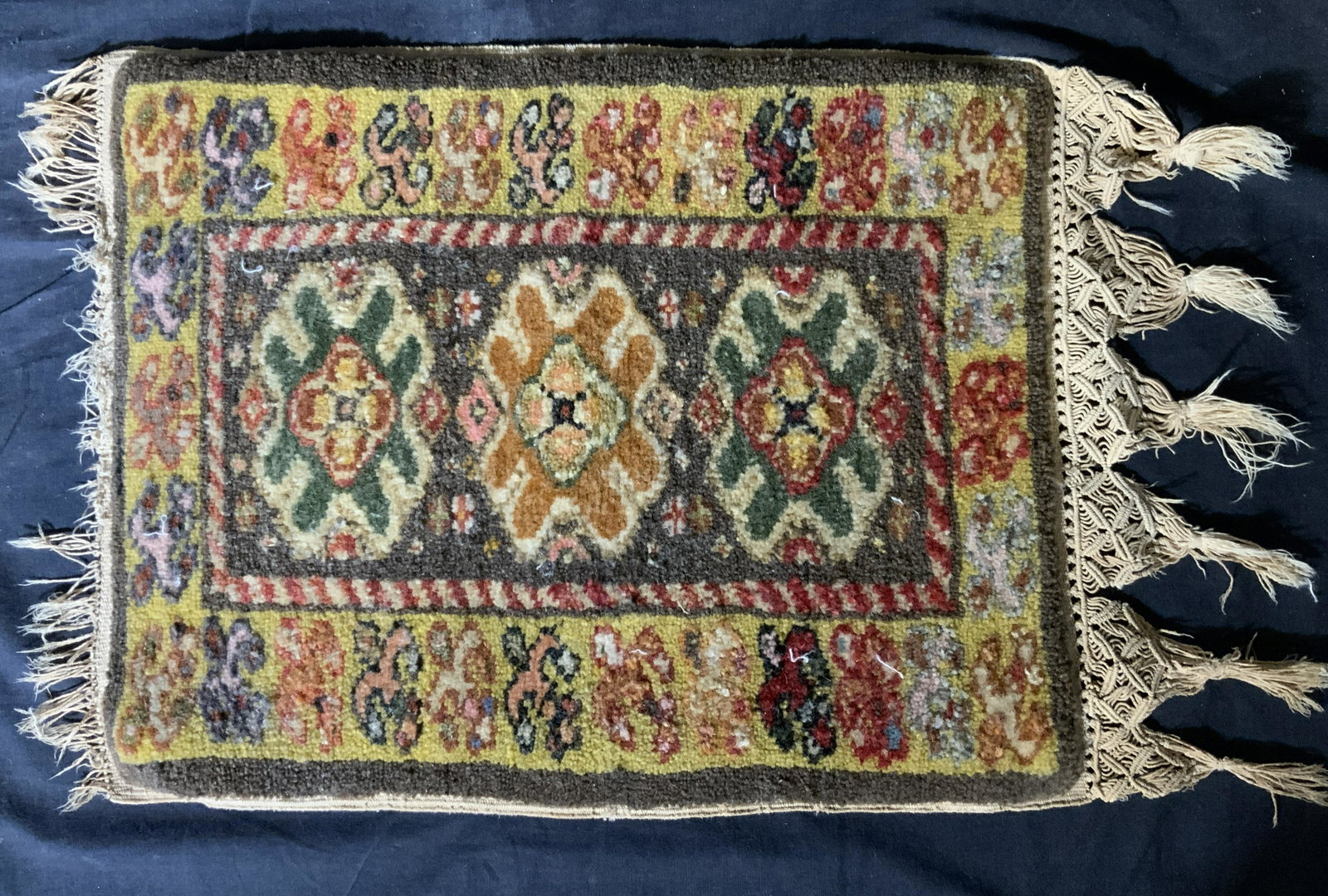 Yellow Toned Persian Rug: Yellow Toned Persian Rug, wool material, macrame fringe, Replicated geometric patterns, warm colors, measures approximately 16 inches L (22 inches L with fringe) x 14 inches W. Persian rug, area rug, 