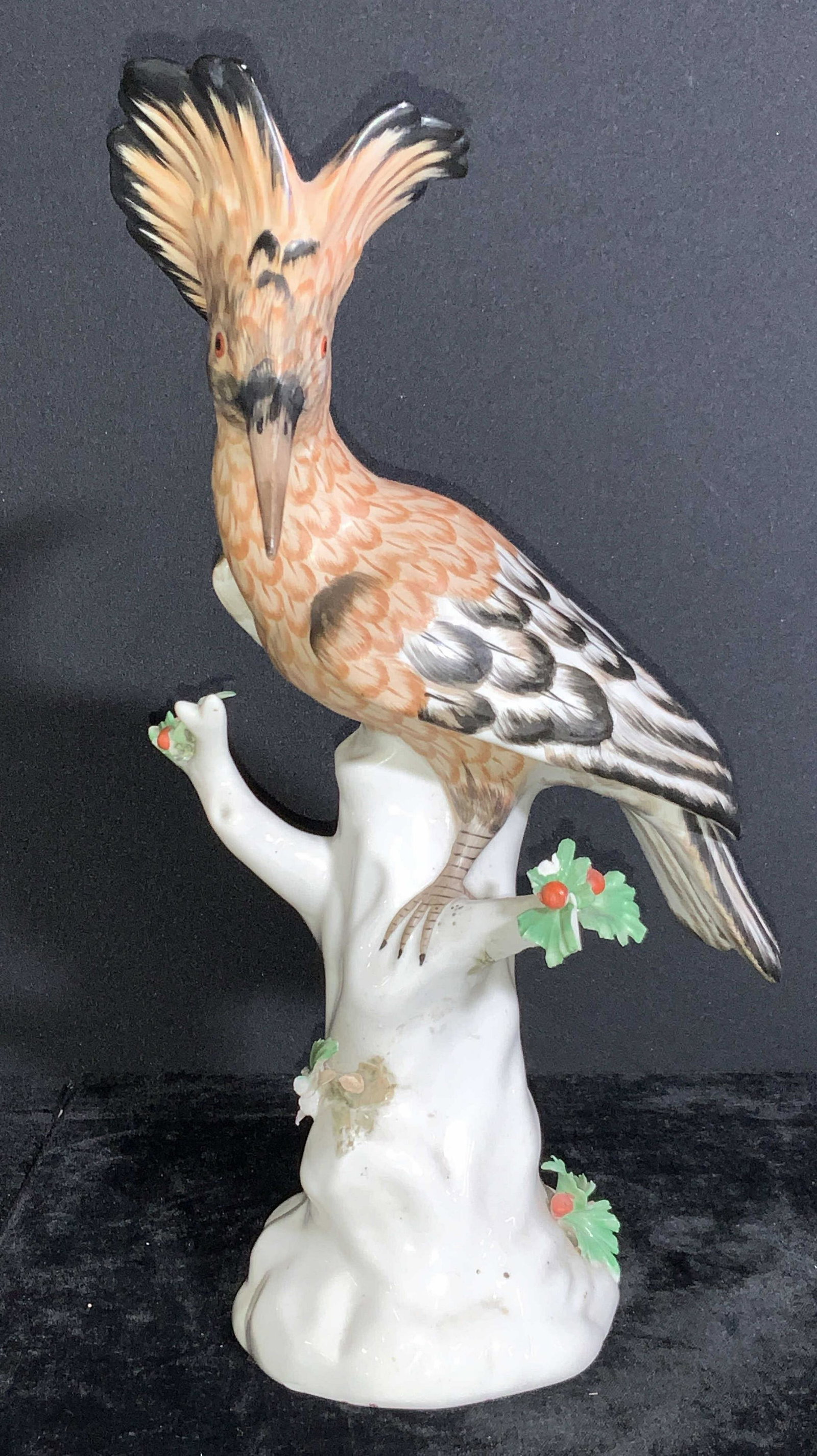 Porcelain Hoopoes Bird Sculpture: A porcelain sculpture of a Hoopoes bird perched on a blossoming tree. The bird is hand painted with intricate brushwork to the feathers throughout the bird, the three is white is color but has green l