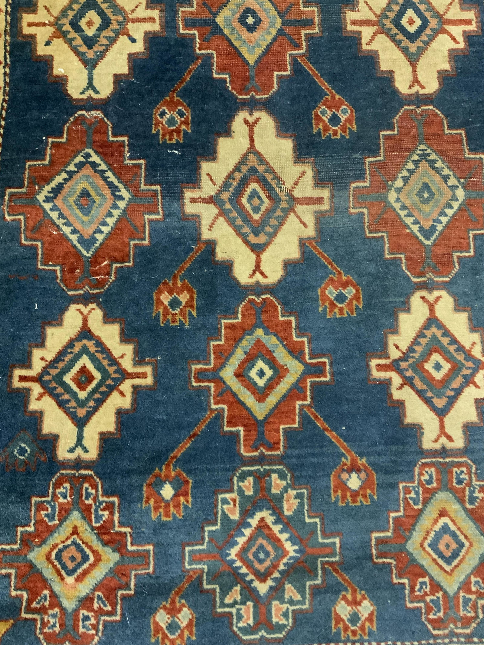 Vintage Turkish Area Rug: Vintage Turkish area rug. Wear is consistent with age and use, wear to ends, pulling to edges. Decorated with multi toned geometric and floral patterns. Measures approx 55 inches long, 37 inches w. Ho