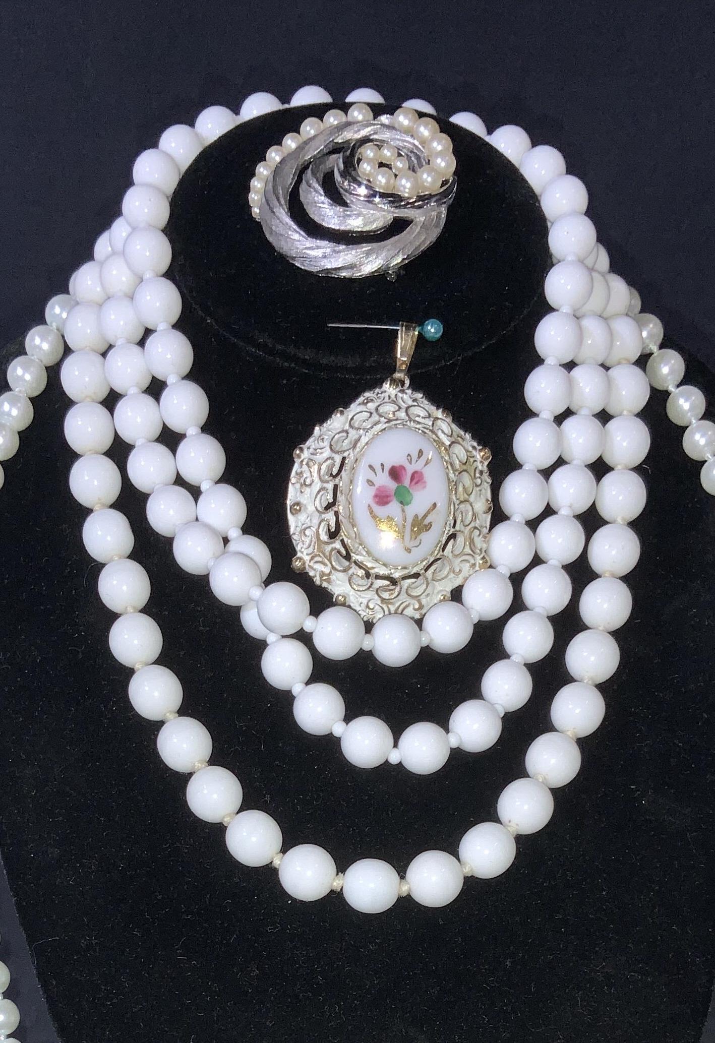 Lot7 Assorted Costume Jewelry, Trifari, More: Natural white stone bead necklace , 16 in. Double knotted. Worthington Signed Lightweight white bead necklace , 28 in. 60 in. Silver toned glass faux pearl necklace, double knotted. Champagne pearlesc