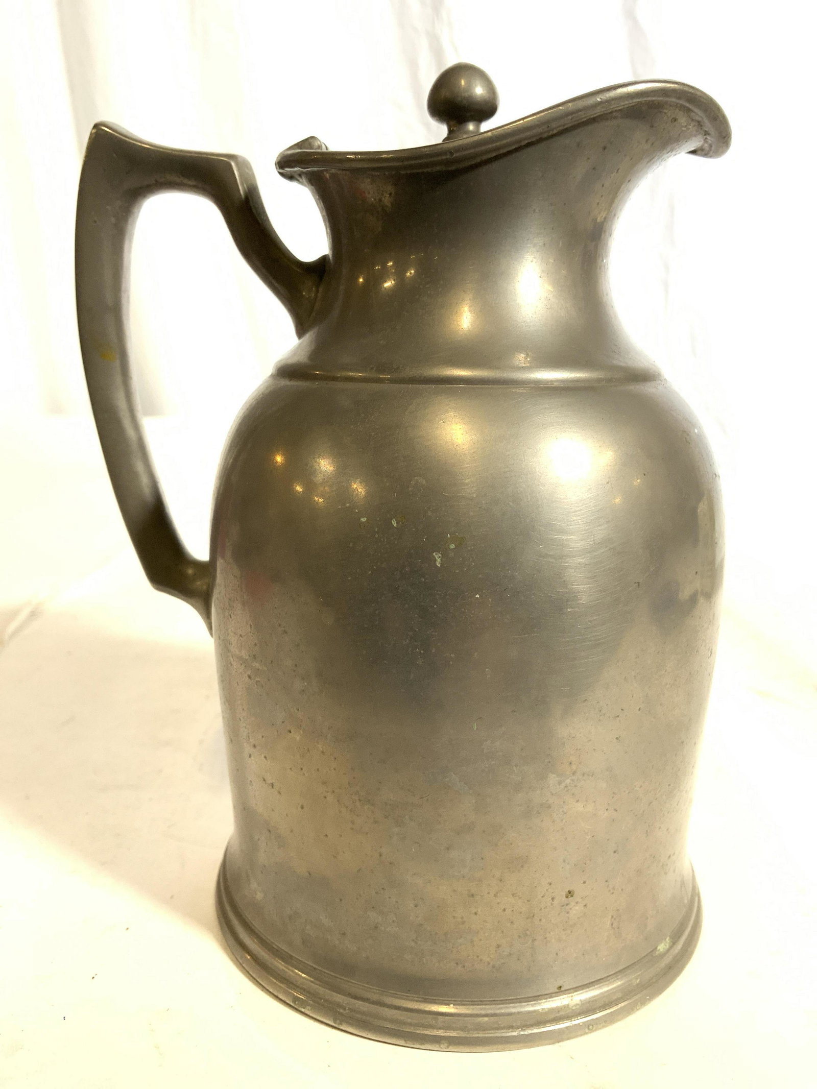 STANLEY INSULATING CO Lidded Metal Teapot: Teapot is inscribed STANLEY INSULATING CO on underside. Teapot has hinged lid. Piece is silver toned and appears to be pewter. Teapot measures approx 6.5 inches tall 4.5 inches wide 5 inches deep. Tea