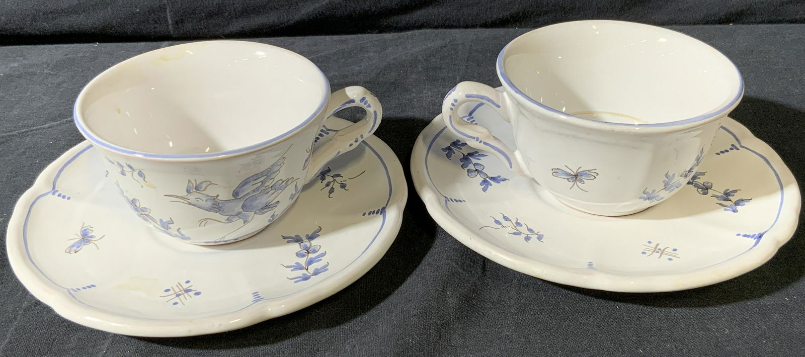 DECOR MOUSTIERS FAIT MAIN Vtg. Tea Cups & Saucers: DECOR MOUSTIERS FAIT MAIN Vintage Pair of Porcelain Tea Cups & Saucers, made in France, white with powder blue floral motif featuring bird and butterfly, condition consistent w age and use, saucers ve