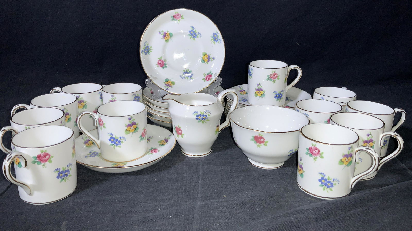 26 STAFFORDSHIRE English Bone China Tea Set: A set of Crown Staffordshire bone China consisting of 26 items. 12 saucers, approximately 5 inches wide, 12 tea cups approximately 2.25 inches tall, 1 creamer, approximately 3 inches tall and 1 footed