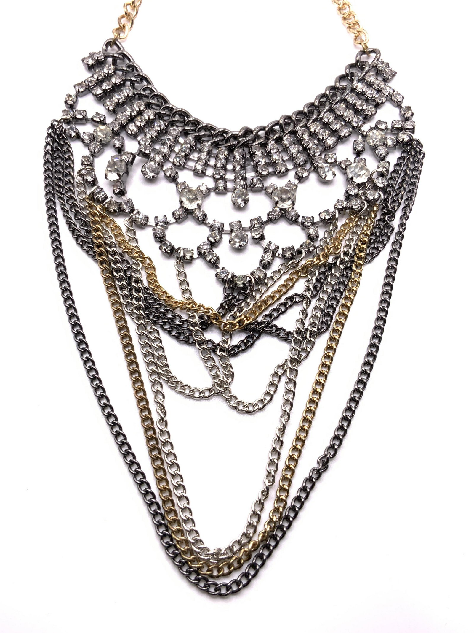 Vintage Multi Chain Crystal Bib Necklace, Jewelry: A vintage necklace comprised of silver, gold, and gunmetal toned chains alongside faceted crystals. Bib style. Adjustable length. Secures with lobster claw clasp. Necklace length approx 21 in. Some su