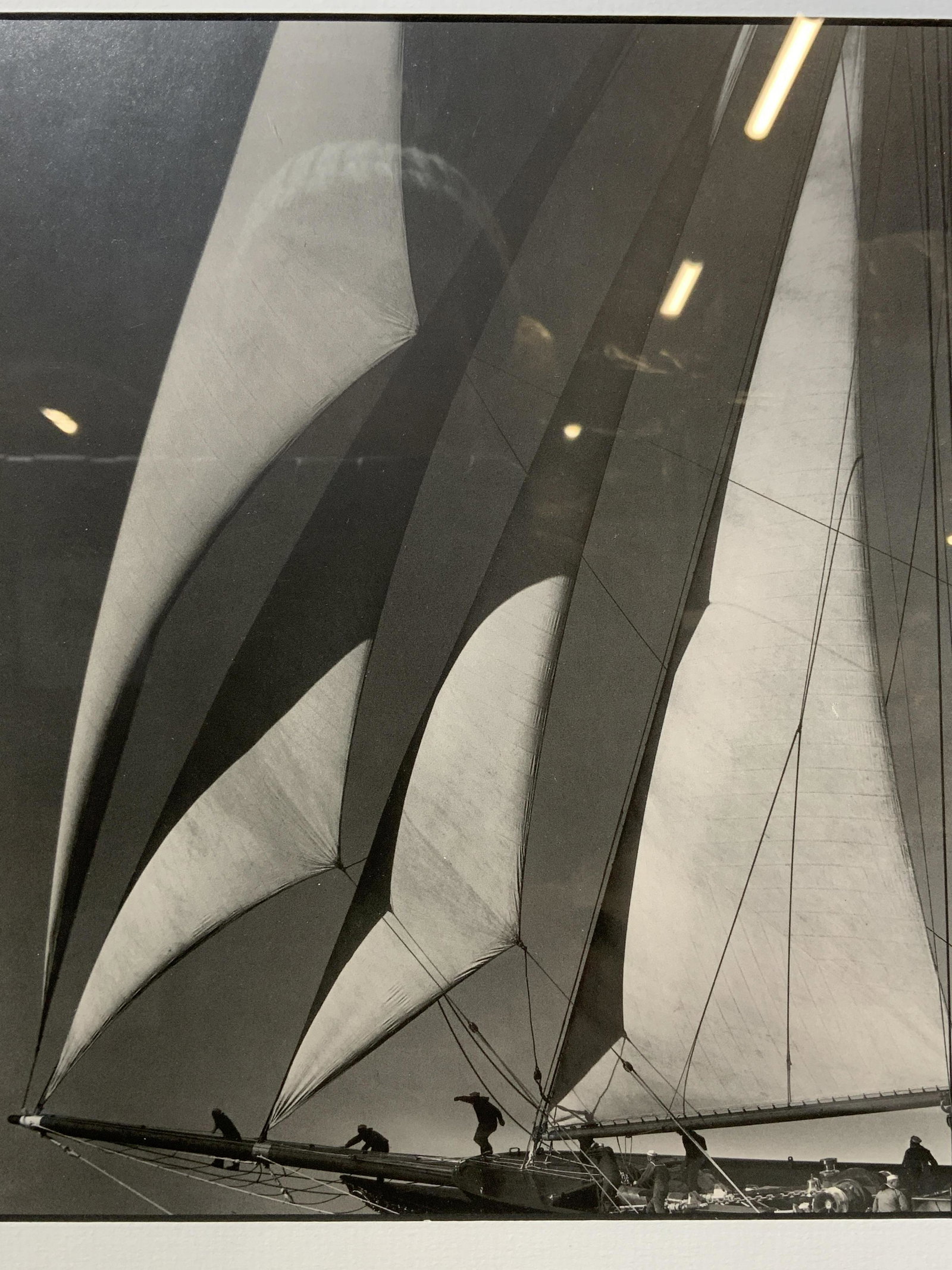 Framed Lithograph of Sail Boat: Framed Lithograph of Sail Boat, no apparent signatures, verso reads MIGRANT HEADSAILS 1934, shows men on a sail boat, measures 13 1/4 x 114 1/2 inches, black toned wood frame, surface wear to frame, p