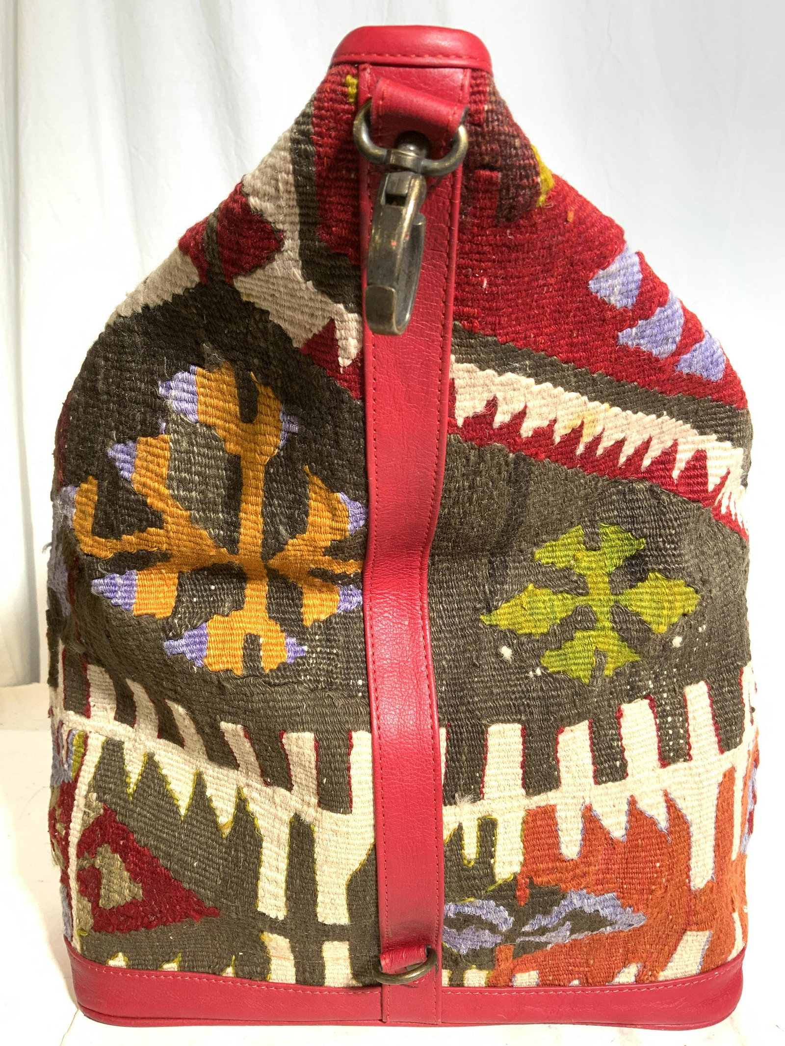 THE LOOM ALASKA Kilim Style Bag: Interior reads THE LOOM ALASKA. Bag has Kilim style wool exterior with multi toned geometric detail. Piece appears to possibly be wool. Piece has top zipper, side zipper & zippered strap. Piece when f