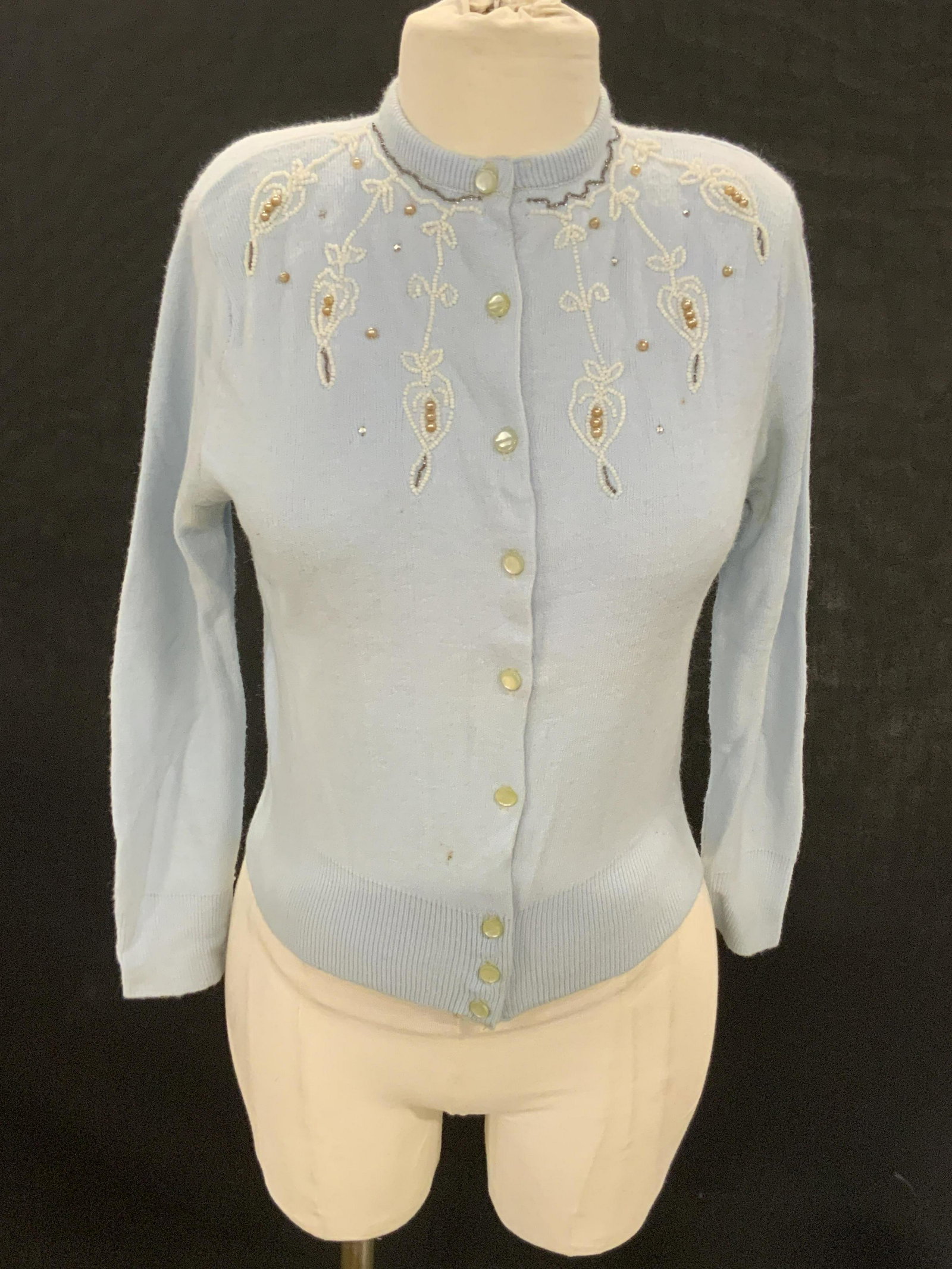 Vntg Blue Du Pont HiBulk Interlock Knit Sweater: A vintage blue sweater decorated with seed beads, pearlescent beads, and rhinestones. Tag reads Fashioned 100% Du Pont Hi-Bulk Turbo Orlon Interlock Knit, Stylabest Knitting Mills, NY. Fits Approx Sma