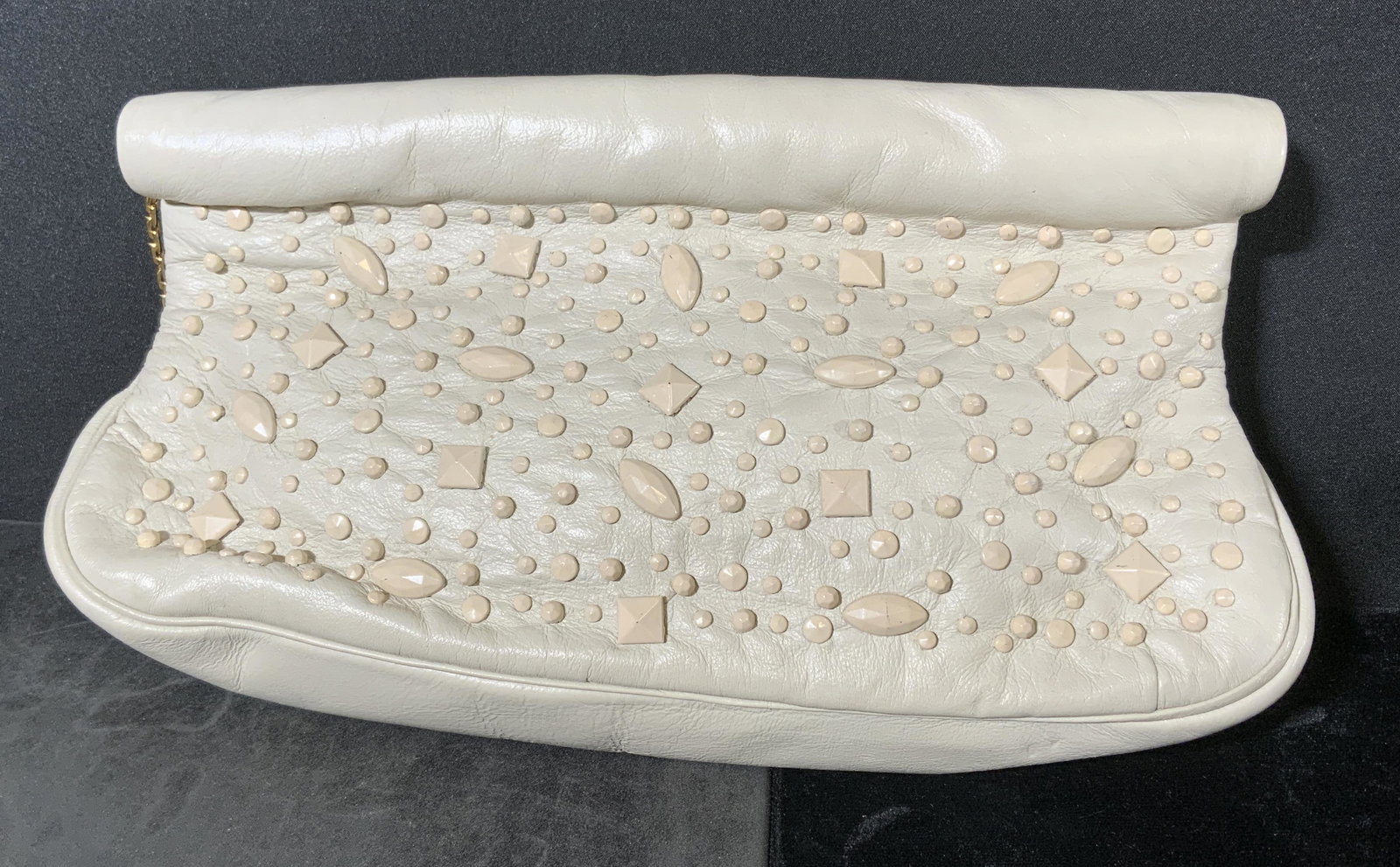 MORRIS MOSKOWITZ Capeskin Clutch: Cream toned clutch. Inside reads as MM Capeskin. Surface wear consistent with use. Studded exterior. Measures approx 6 inches h and 10 inches w. Fashion Accessories, Ladies accessories, Gifts, Satchel