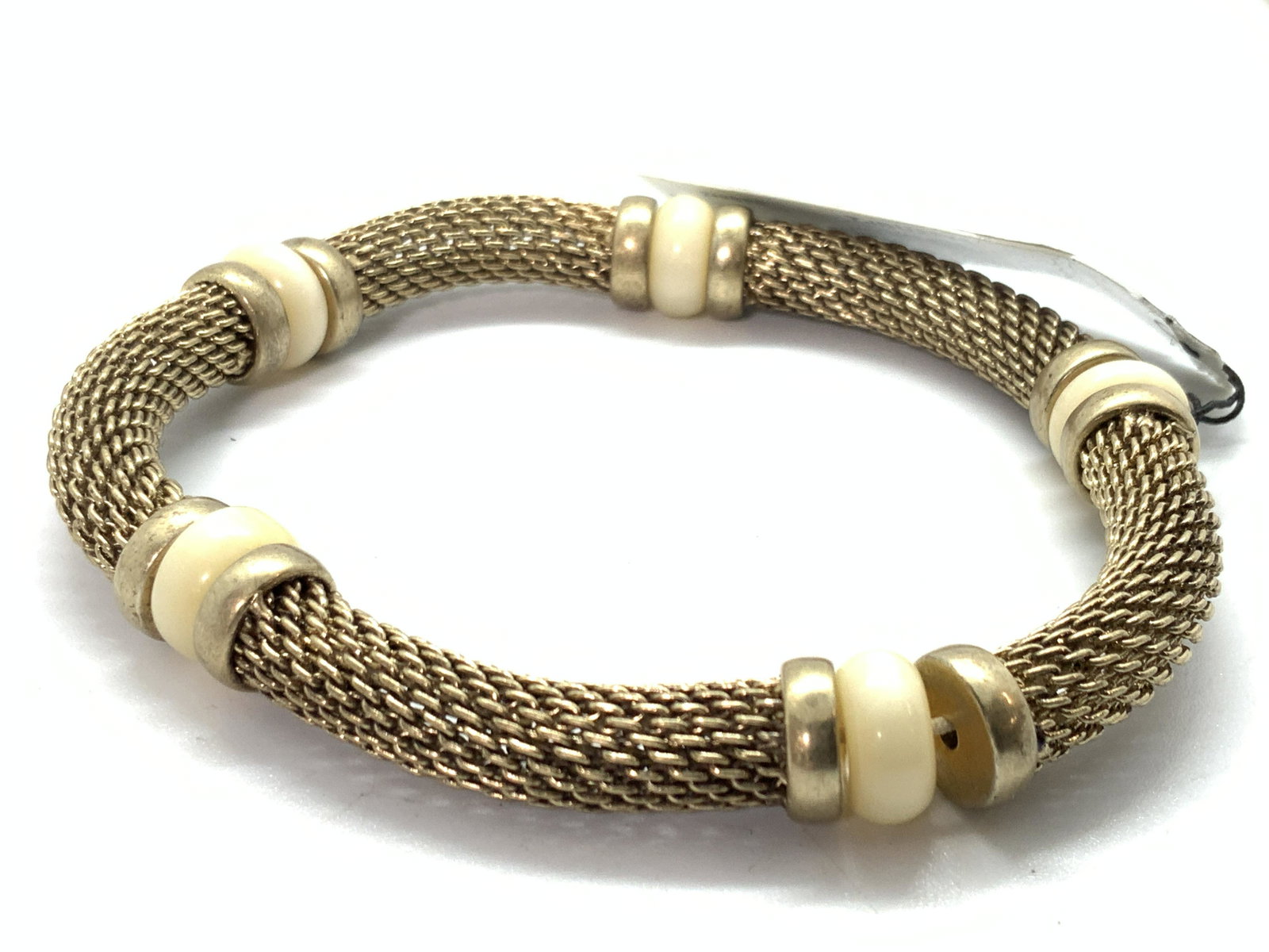 Ellen Tracy Gold Toned Knit Chain Stretch Bracelet: Bracelet made of knit chain with pearlescent spacer beads. Has tag marked Ellen Tracy. Approximately 3 inches wide. Ellen Tracy Designer bracelet, designer bracelet, designer jewelry, Vintage Jewelry,