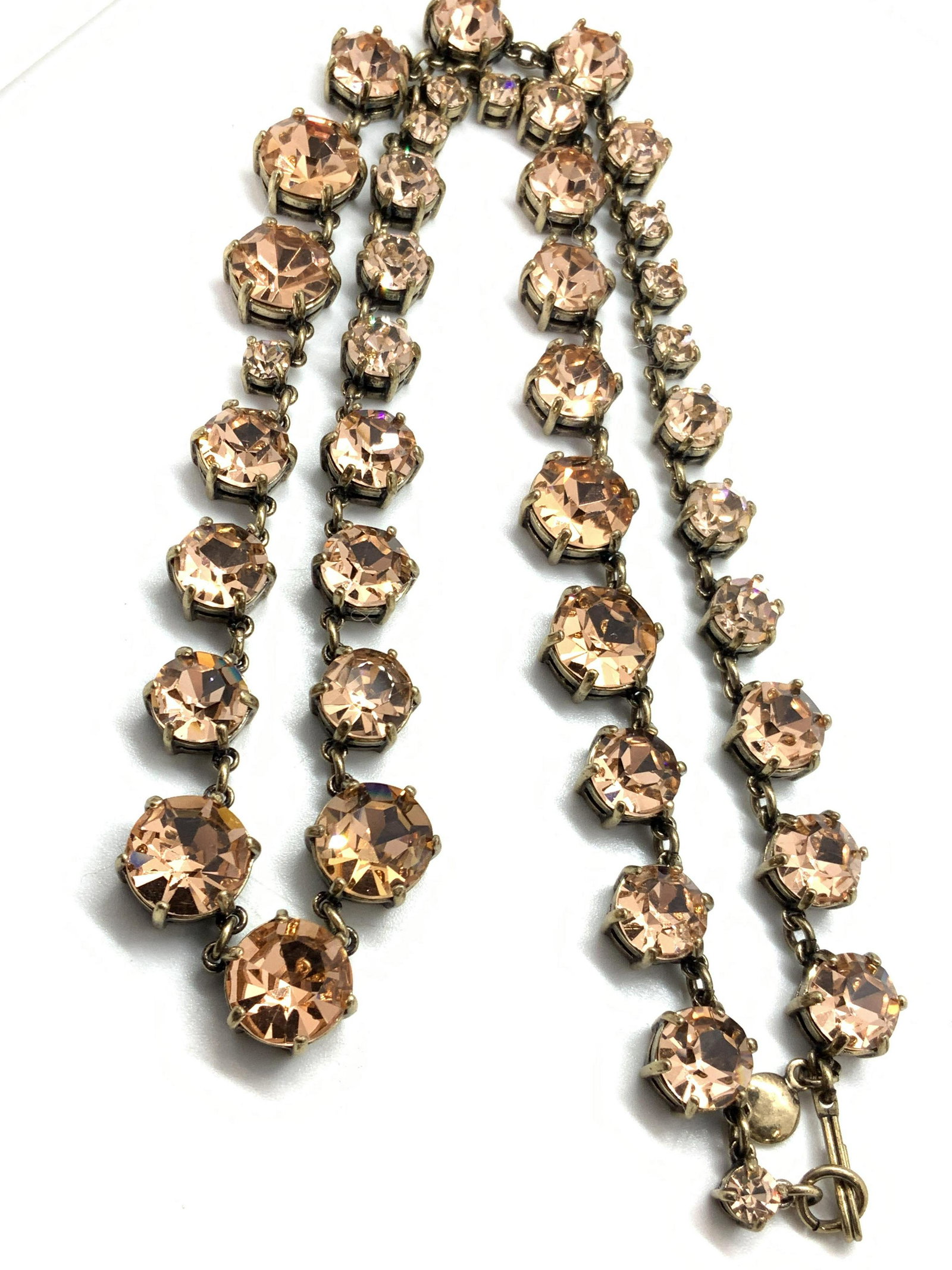 J.Crew Brass Toned & Pink Bracelet & Necklace: A set of J.Crew necklace and bracelet with brass toned metal with pink faceted stones. Marked J.Crew on clasps. Bracelet is approximately 7.25 inches long, necklace is approximately 11 inches long. J.