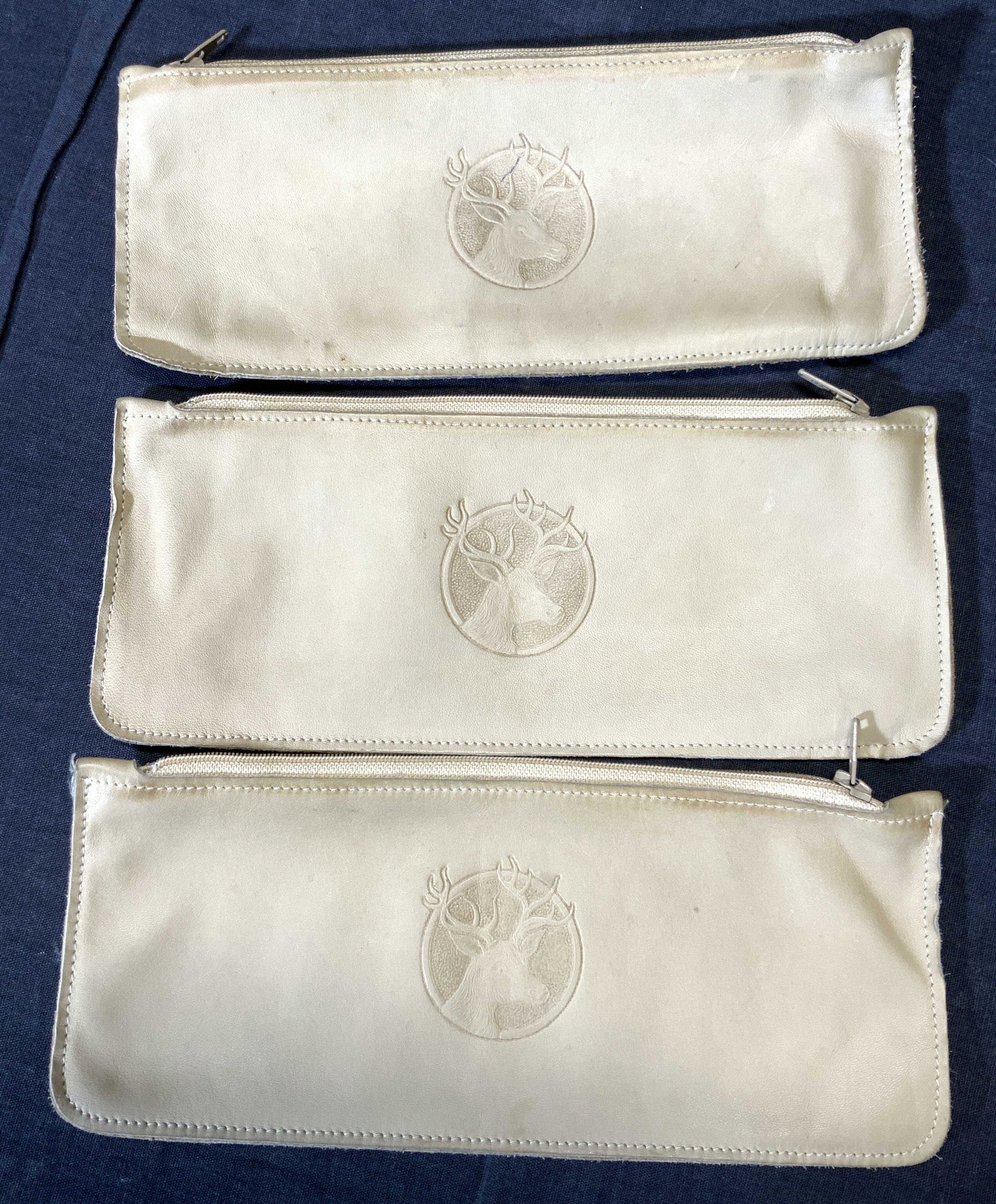 3 FERREE Wild Elk Leather Hand Bag, Canada: 3 Elk leather hand bags with embossed exterior design on an elf, marked on backside Ferree Wild Elk, Canada. Approximately 8.75 inches long and 3.75 inches wide. Some blemishes. Property of Manhattan,