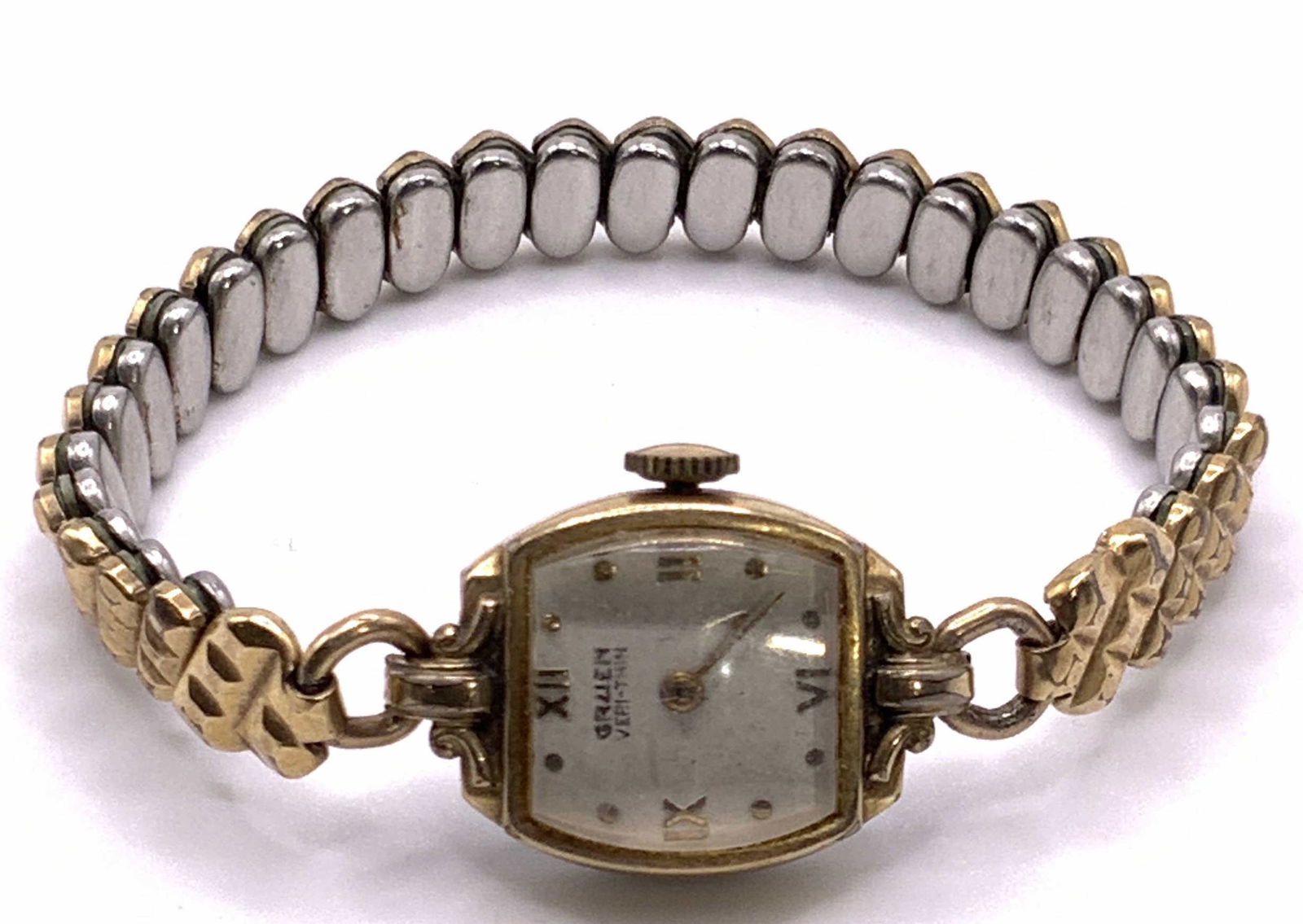 GRUEN 10K Gold Filled Ladies Stretch Wristwatch: A gold filled stainless steel backed stretch wristwatch. Watch face reads GRUEN. Interior is marked 10K GF, SS back. Diameter Measures approx 2 in. Collectible jewelry, Vintage Jewelry, Fashion Jewelr