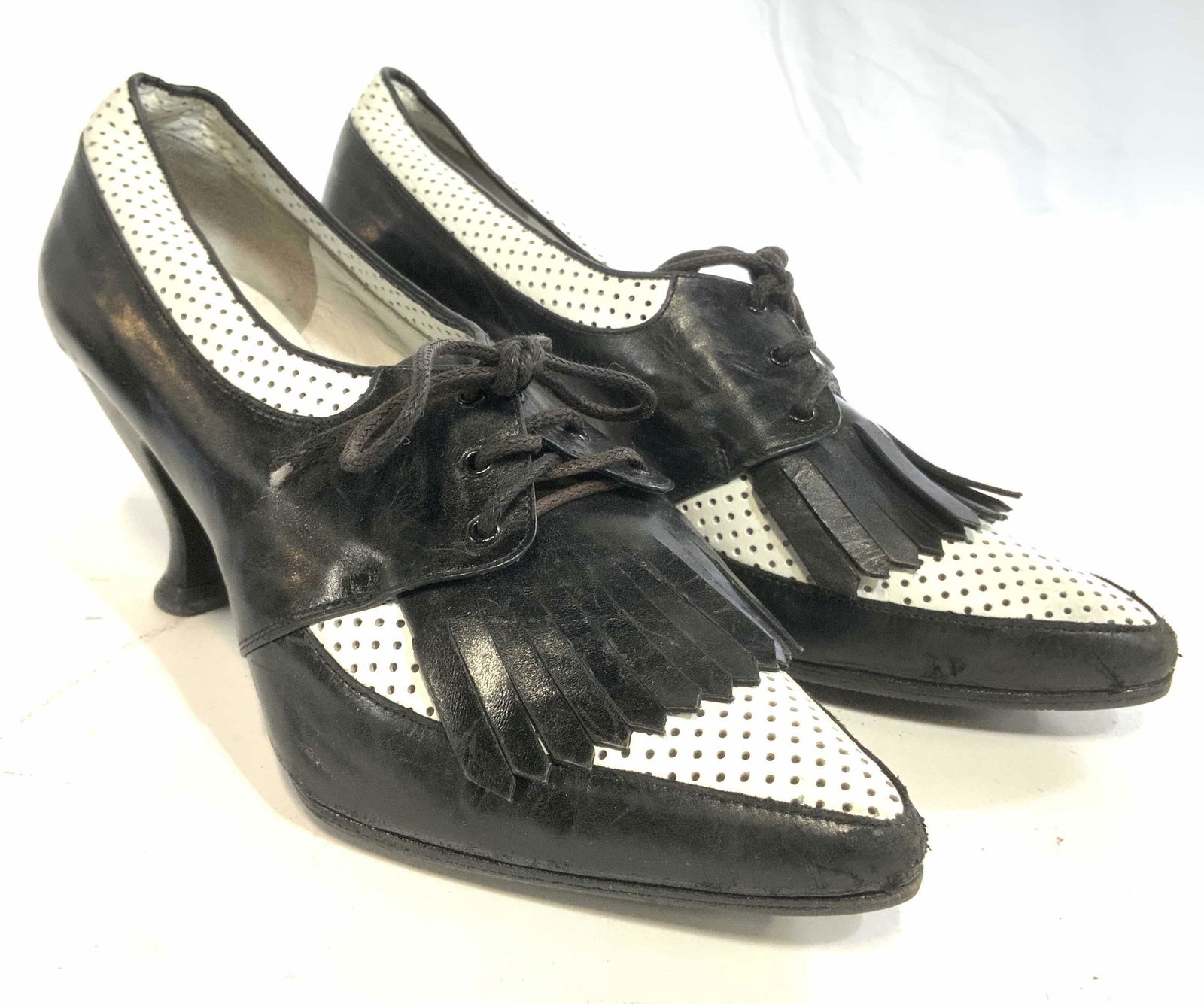 PETER FOX Italian Leather Heels 7 1/2: Undersides are inscribed PETER FOX MADE IN ITALY 7 1/2 B. Heels are black and white toned and appear to possibly be genuine leather. Front of shoe has leather tassel detail. White areas have pierced d