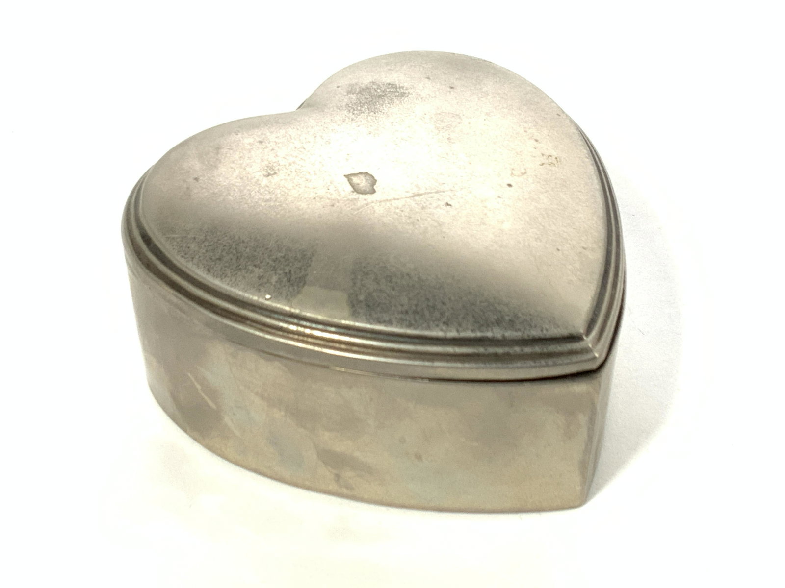 Vintage Silver Plated Heart Trinket Box: A vintage heart shaped box, possibly silver plated. Interior is lined with white fabric. Approximately 3 x 3 x 1.25 inches. Condition is consistent with vintage age and exposure. Silver plated box, tr