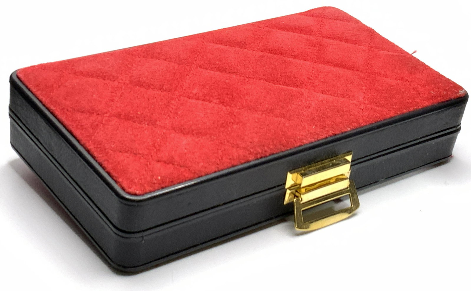 REVLON Manicure Kit W/ Leather Case: A REVLON manicure kit contained in a black case. Exterior of the case features black leather and a quilt style suede leather upper and underside. Interior of case is red velvet style material. Seven p