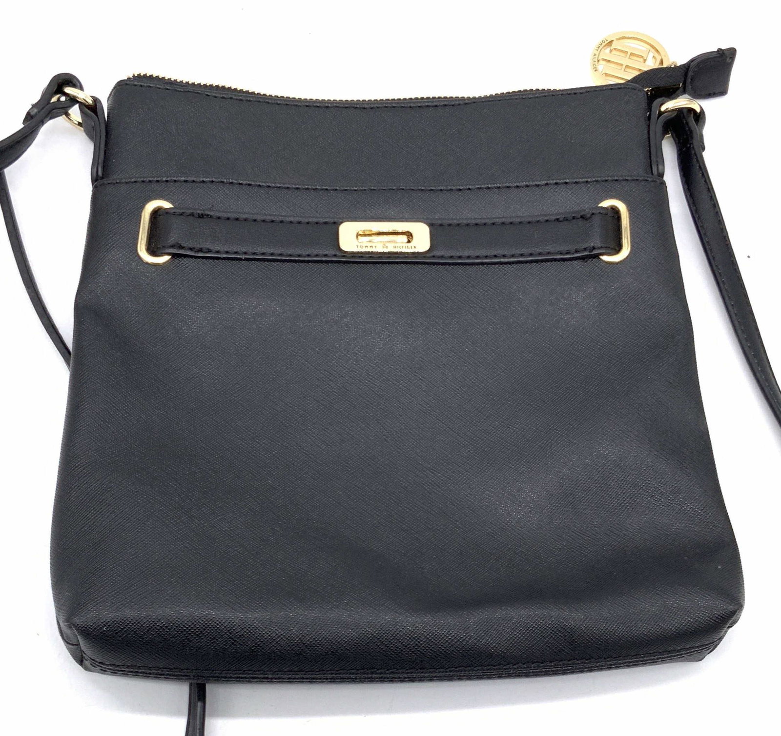 TOMMY HILFIGER Black Leather Shoulder Purse: A black leather style Tommy Hilfiger shoulder purse. Interior lined blue and red. Interior reads TOMMY HILFIGER. Gold tone hardware. Zipper closure. Purse measures approx 10L x 9.5W in. Strap drop app