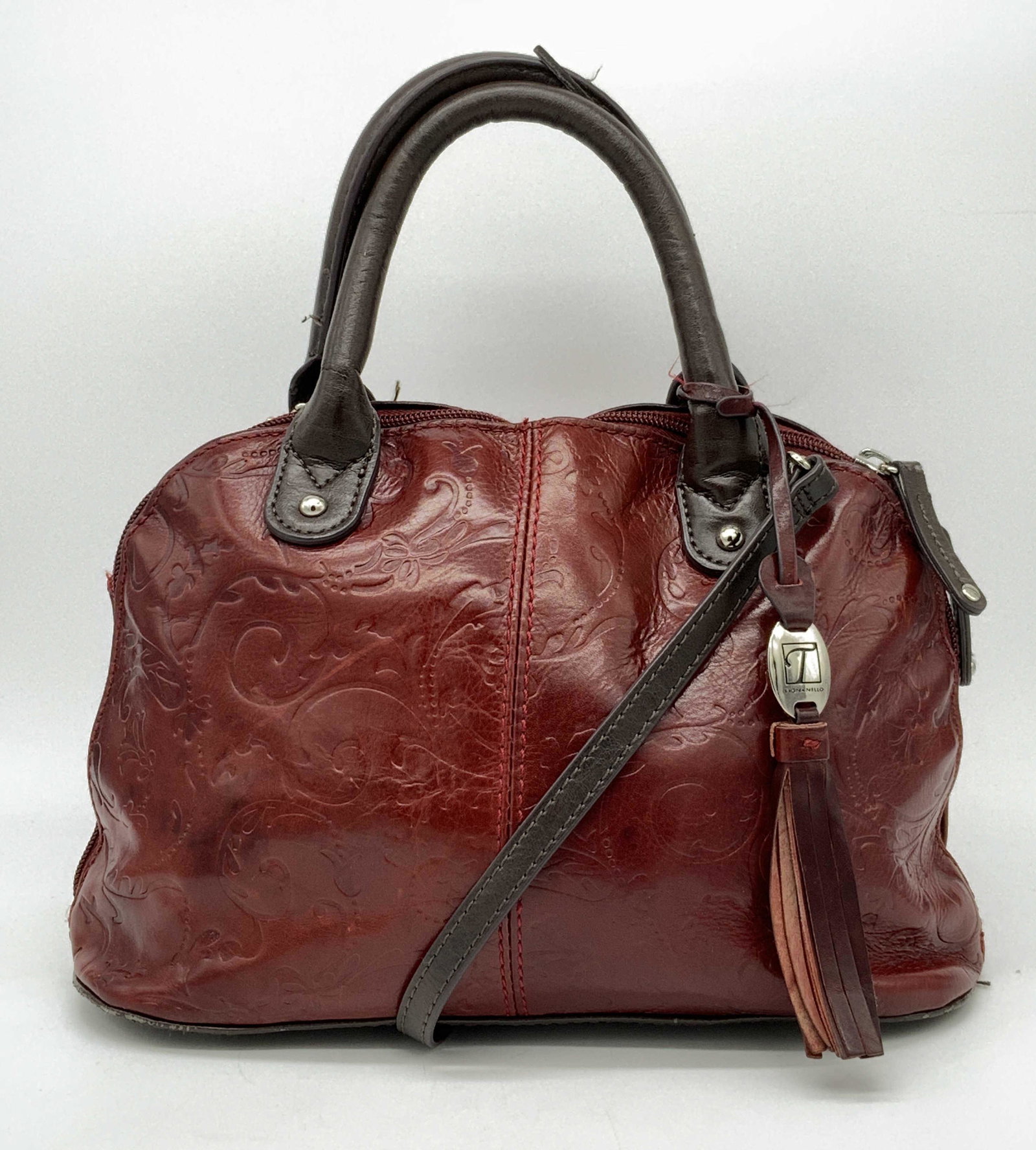 TIGNANELLO Genuine Leather Crossbody Handbag: TIGNANELLO Genuine Leather Crossbody Handbag, embossed red leather exterior with brown leather handles, strap, zippers, and bottom, silver toned metal hardware, exterior has one zipper pocket, strap i