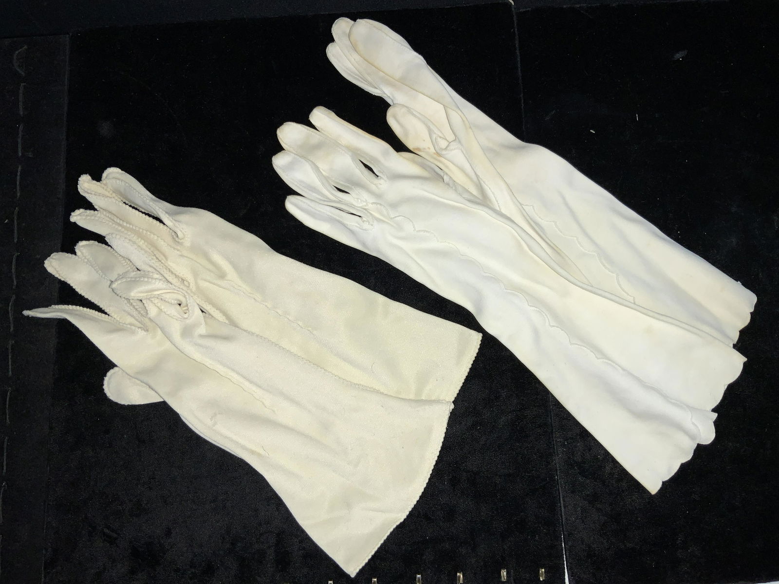 Group Lot 2 Vintage White Cotton Gloves: Group lot of 2 pairs of vintage white cotton gloves. 1 pair longer than the other. With ruffled accent stitching. Longest pair in approximately 13 inches long. Some staining to cloth. Vintage gloves,