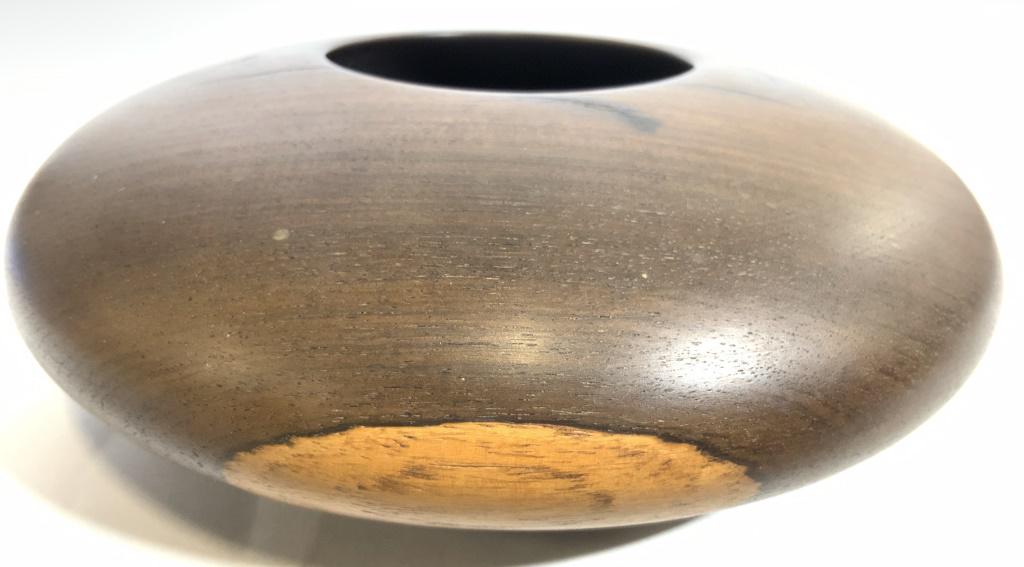 PATRICK Signed Wide Set Wooden Vessel: Underside of vessel is signed PATRICK. Piece appears to be wooden. Vessel is brown toned and has wide set structure. Piece has small mouth. Vessel measures approx 6.5 inches wide 2.25 inches tall. Ves