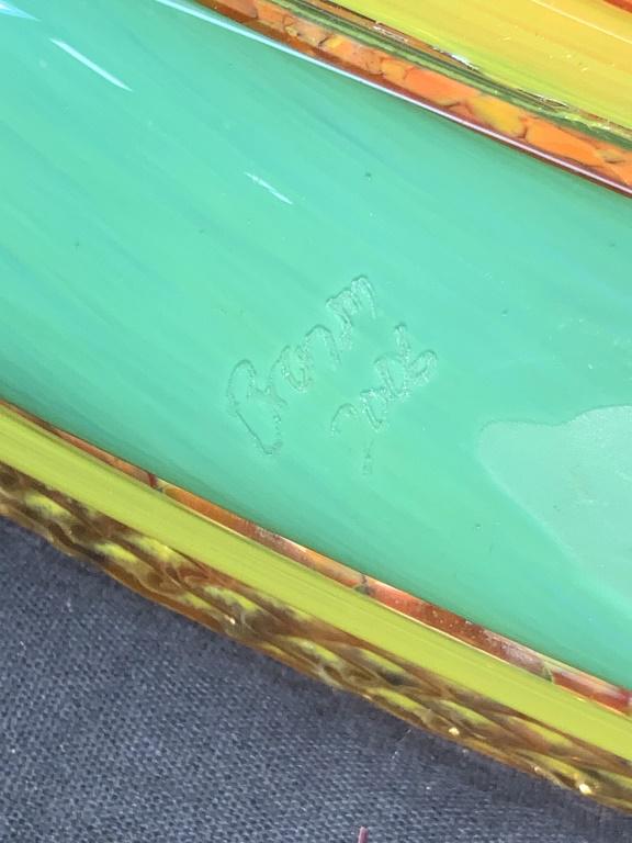 Signed Hand Blown Glass Pepper Centerpiece Tray: A signed hand blown glass centerpiece made to resemble a pepper motif. Base of time is teal toned flanked with yellow and the center of the tray is orange with speckled of yellow. Signed on underside,