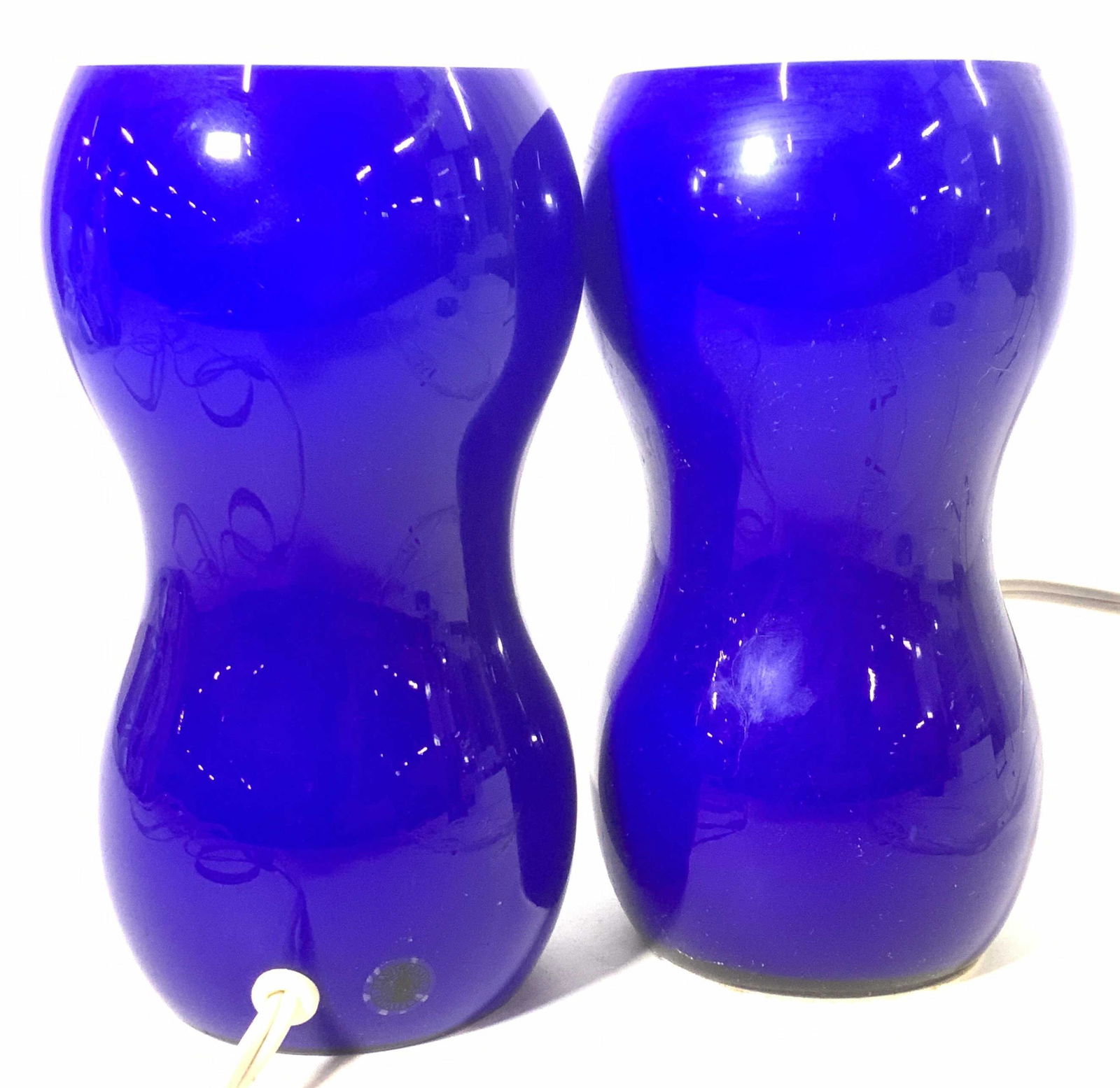 Pair IKEA Handmade Cobalt Blue Glass Lights: IKEA Colored Glass corner floor lights, handmade glass ( sticker on one piece) , both cobalt blue, double gourd shape. Mid century modern style, Light switch on cord. Cord measures 9 ft. Light measure