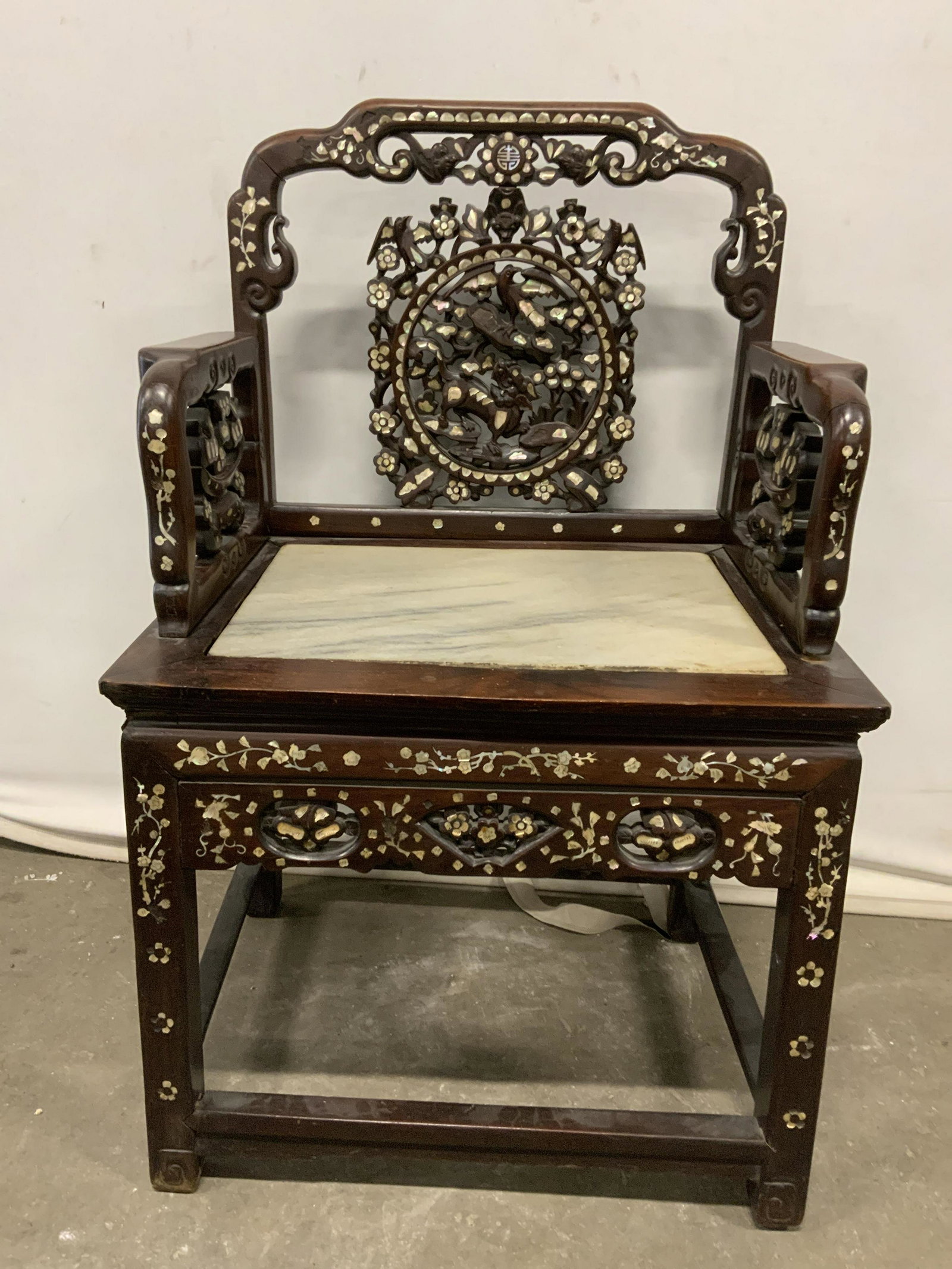 Vintage Asian Style Armchair w Pearl Inlay: Vintage, possibly antique, armchair. Asian styled, inlaid mother of Pearl floral patterns. Seat is marble. Wear is consistent with age, loosening of joints, surface wear and loss present, care require