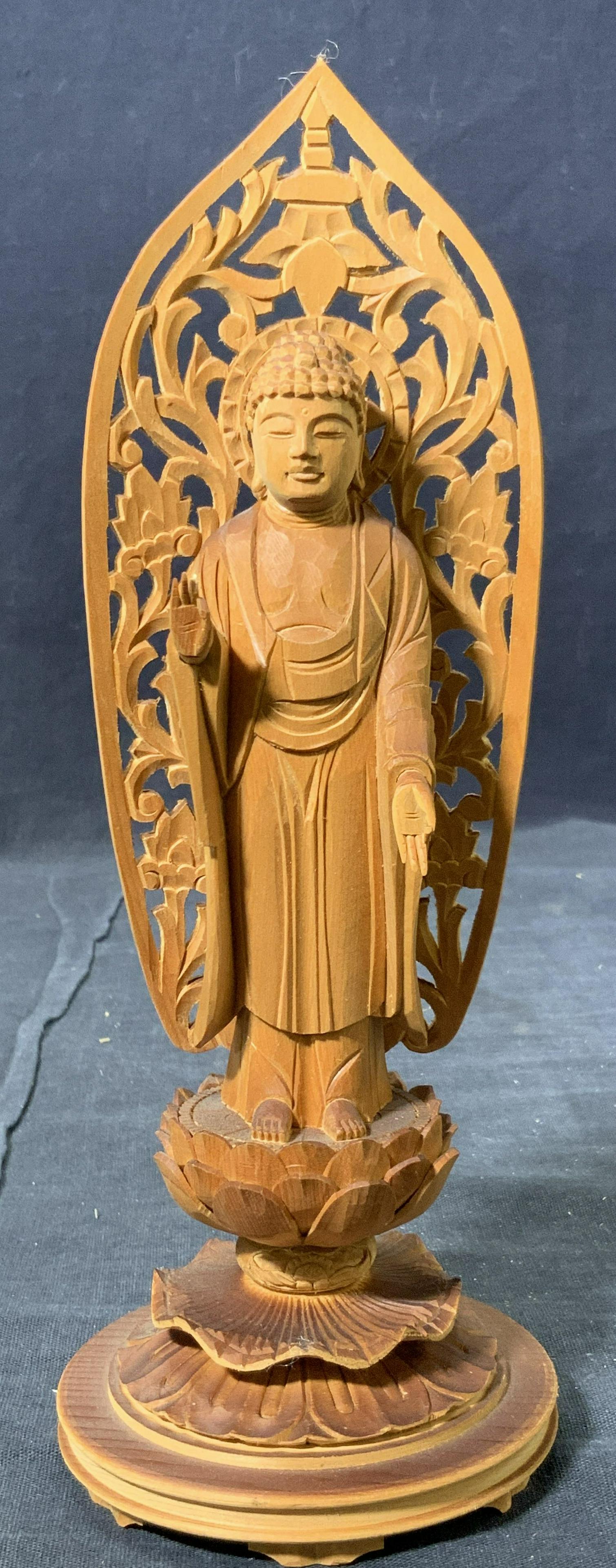 Carved Sandal Wood Buddha Figure: Hand carved sandal wood figure of the Abhaya Mudra Buddha, on a lotus base. The Abhayamudra gesture of fearlessness is a mudra (gesture) that is the gesture of reassurance and safety, which dispels fe