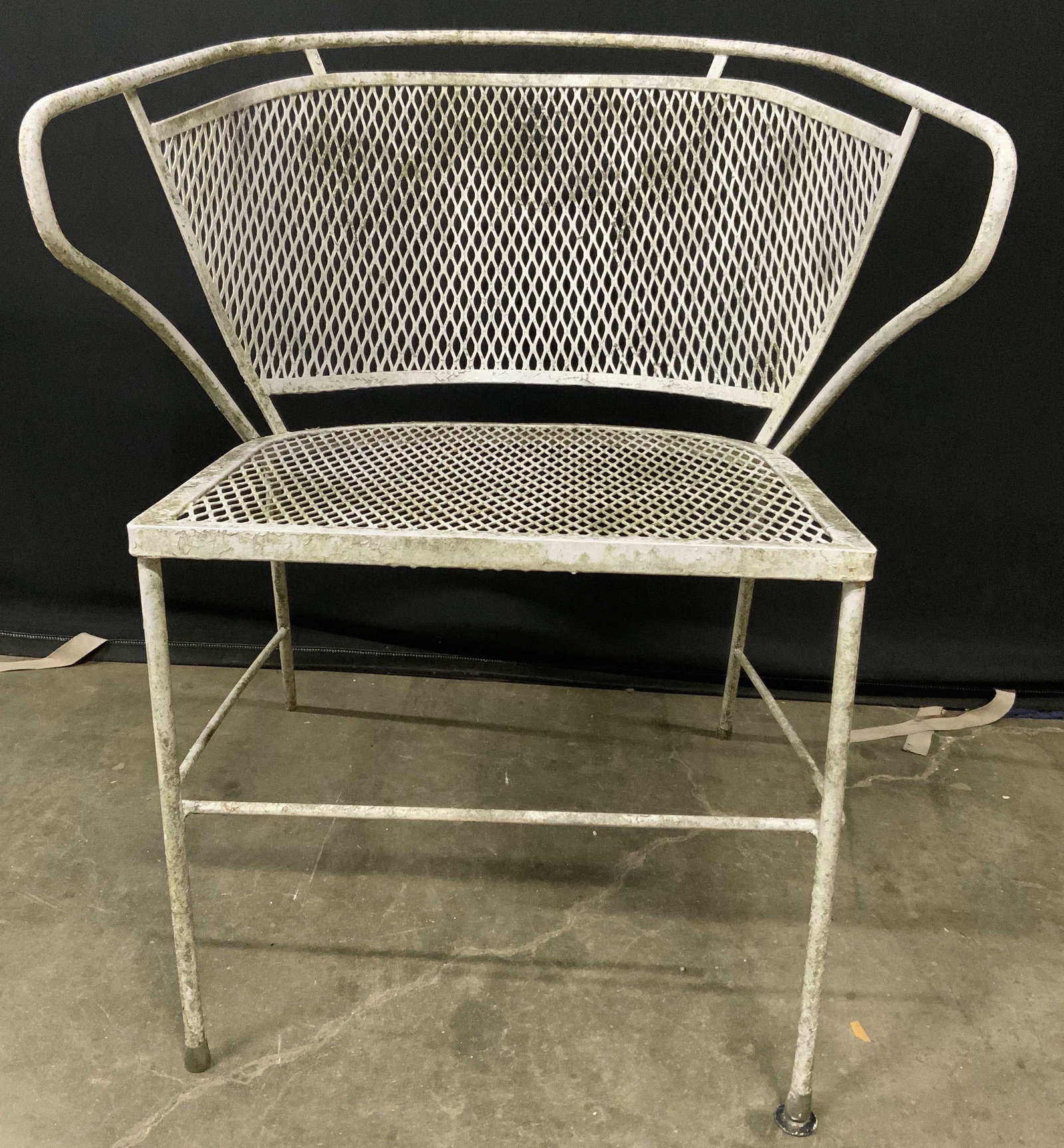 Outdoor Metal Patio Chair: Metal patio chair, possibly vintage. Painted white. Surface wear consistent with age and exposure. Measures approx 29 inches h, 24 inches w, 22.5 inches deep. Home decor, decorative accessories, decor