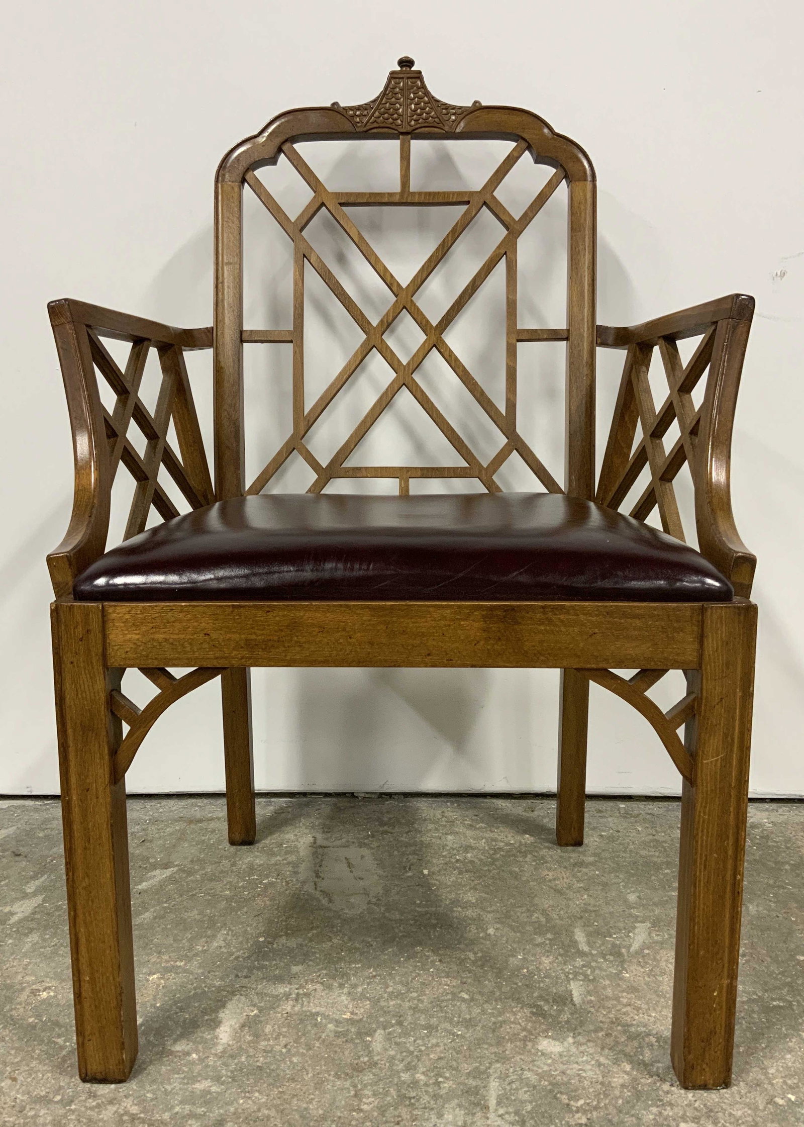 Chippendale Style Chinoiserie Arm Chair: Vintage wooden armchair, Chippendale design, chinoiserie elements. Top of back carved to resemble a sloping roof. Arms and back sport lattice like designs. Wear is consistent with age and use, surface