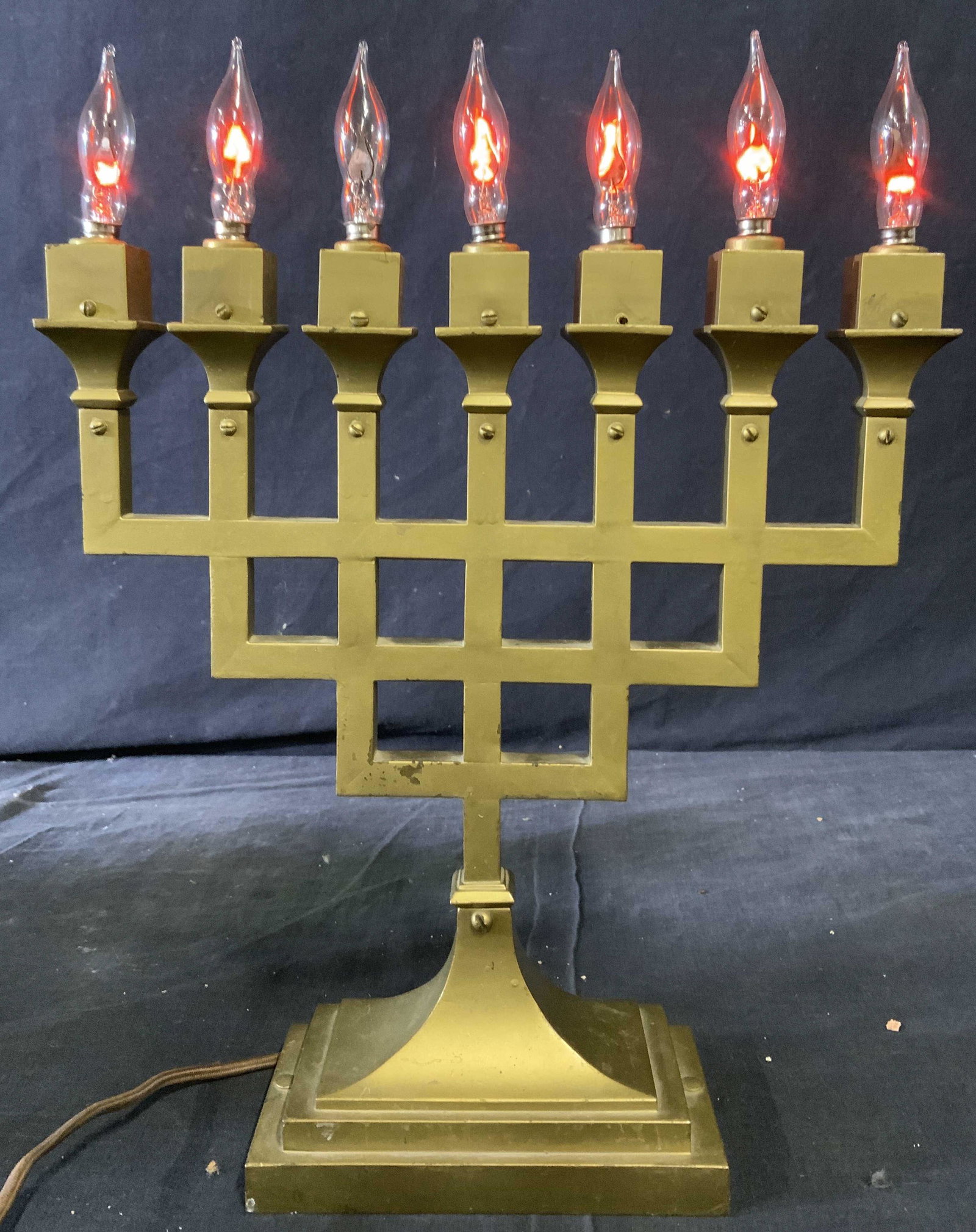 BRADLEY & HUBBARD 7 Branch Menorah C 1900: Menorah was made by BRADLEY & HUBBARD Circa 1900. Menorah is electric and appears to possibly be brass. Piece has 7 arms with flame shaped bulbs at ends. Menorah is Arts and Craft style. Measures appr