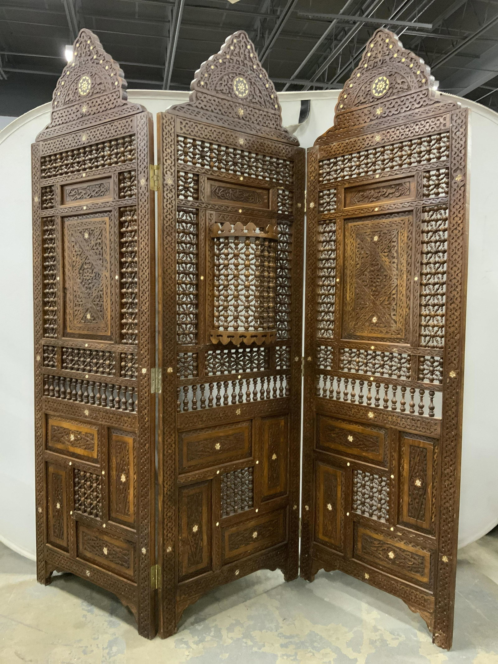 Vtg Moorish Carved Wooden 3 Panel Room Screen: Room screen is vintage. Piece is wooden with intricately carved detail. Screen has carved beaded areas with pierced areas. Center of piece has swinging windowed area. Screen also has carved bone & mot
