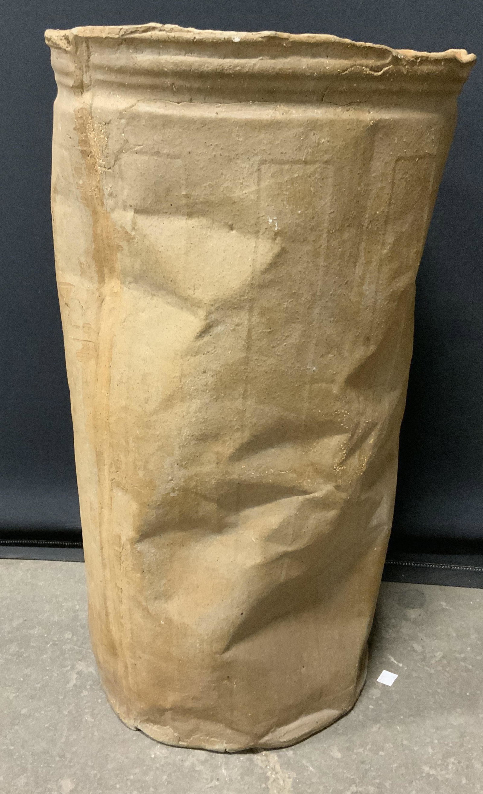 Cast Ceramic Vessel: Cast ceramic bin, cast crumpled form. No apparent signatures. Chipping and surface wear present. Measures approx 25 inches h and 13.5 inches in diameter. Interior is glazed. Home decor, ceramic vessel
