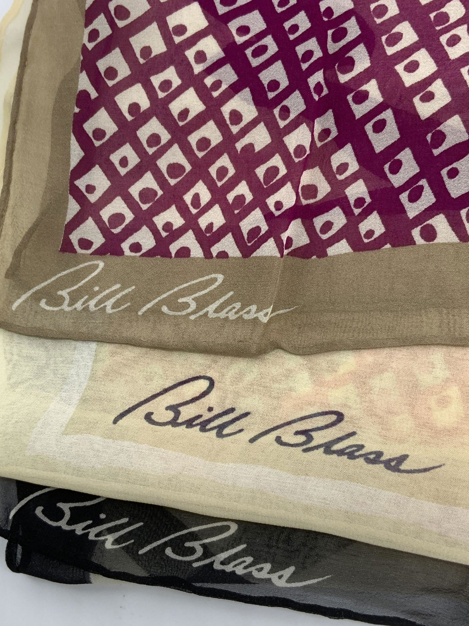 BILL BLASS Lot of 3 Silk Scarves: BILL BLASS Lot of 3 Silk Scarves, one with beige, cream, and violet tones & geometric design, second with beige, cream, white, tan, and blue with repeating square design, some blemishes, third with be