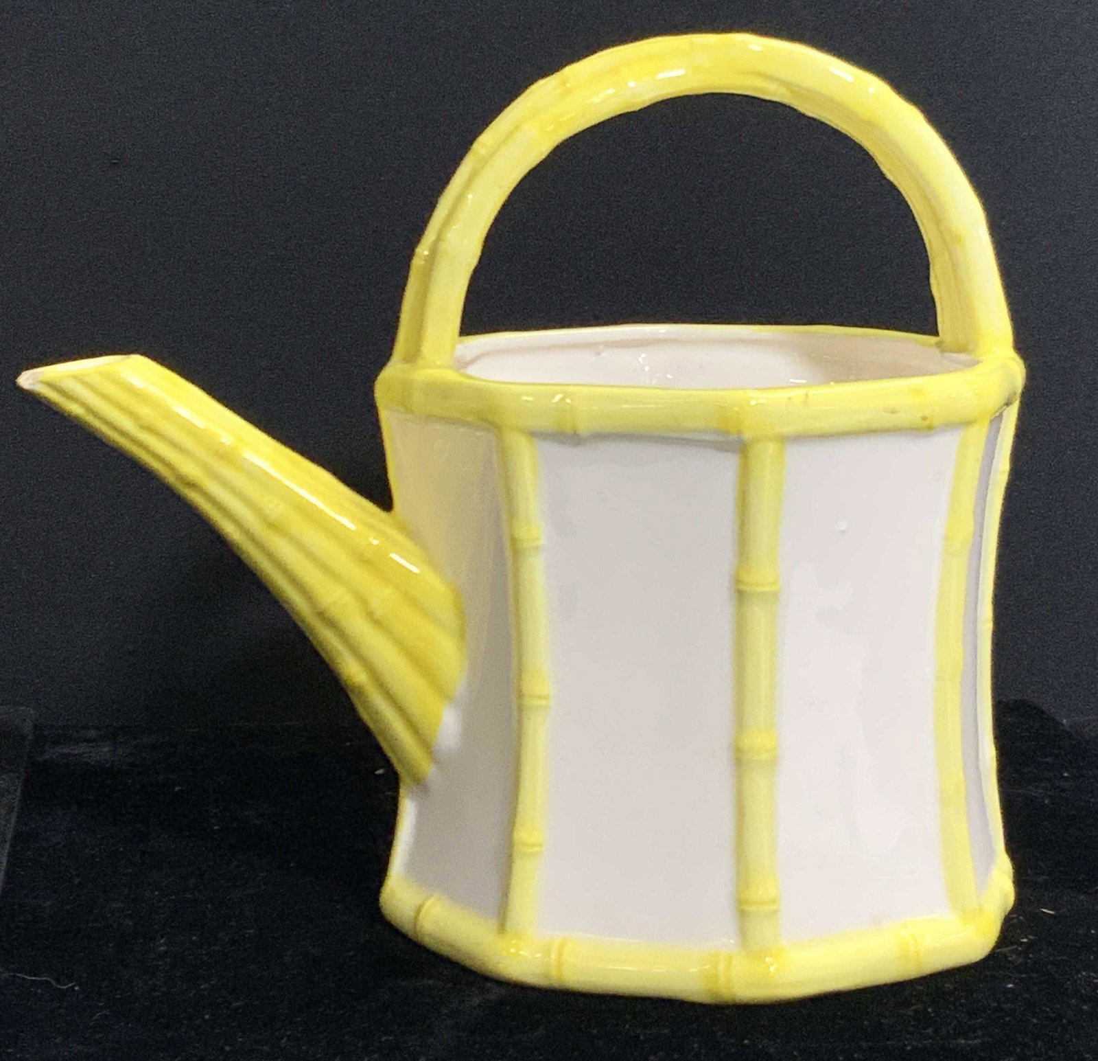 Fritz and Floyd Ceramic Yellow Watering Can, Japan: A ceramic watering can, with yellow bamboo like rim, handle and nozzle. Marked Fritz and Floyd on underside, Japan. Approximately 8.5 inches tall and 8.75 inches long. Chipping to nozzle, hairline cra