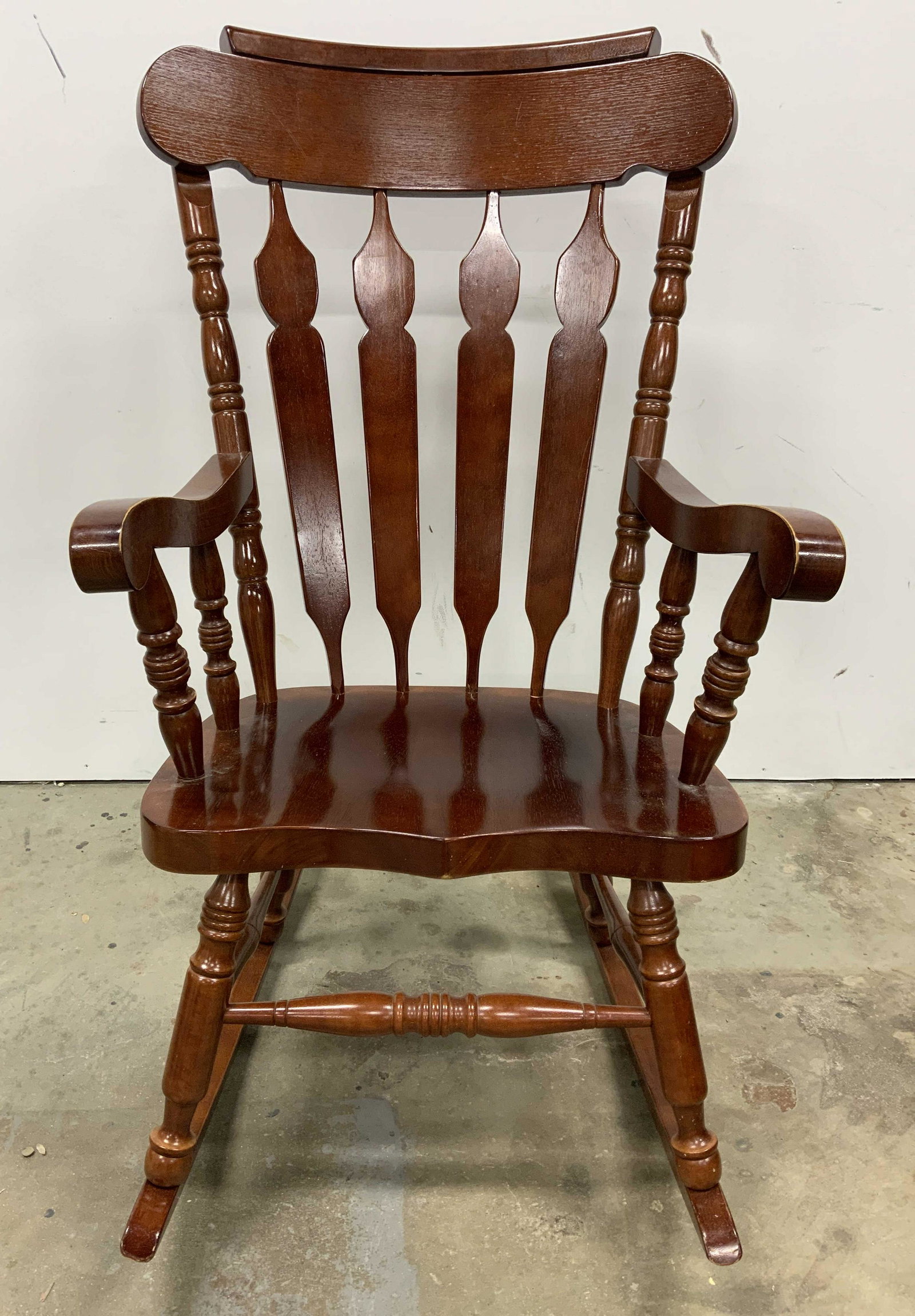 Wooden Rocking Chair w Cushions: Wooden rocking chair with cushions, possibly vintage. Cushions are removable, tassels secure cushions to chair. Surface wear to chair and cushions. Underside reads as Made in Malaysia. Measures approx