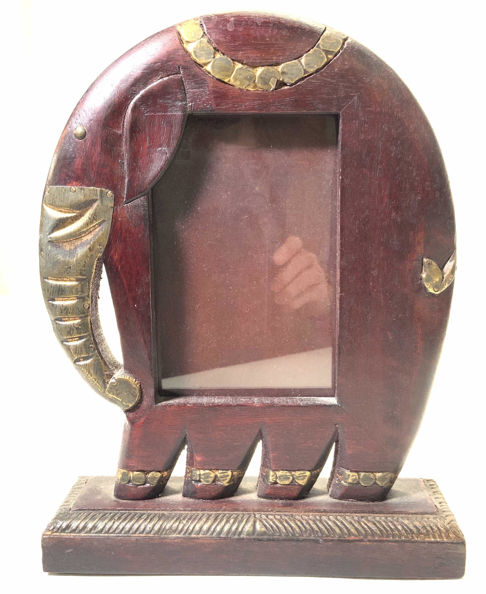 Vintage Carved Wood & Copper Elephant Frame: A vintage photo frame made of carved wood in the shape of an elephant, stained a purple redish tone with accents made of copper plating on elephants trunk, tail and decorative saddle. Approximately 11