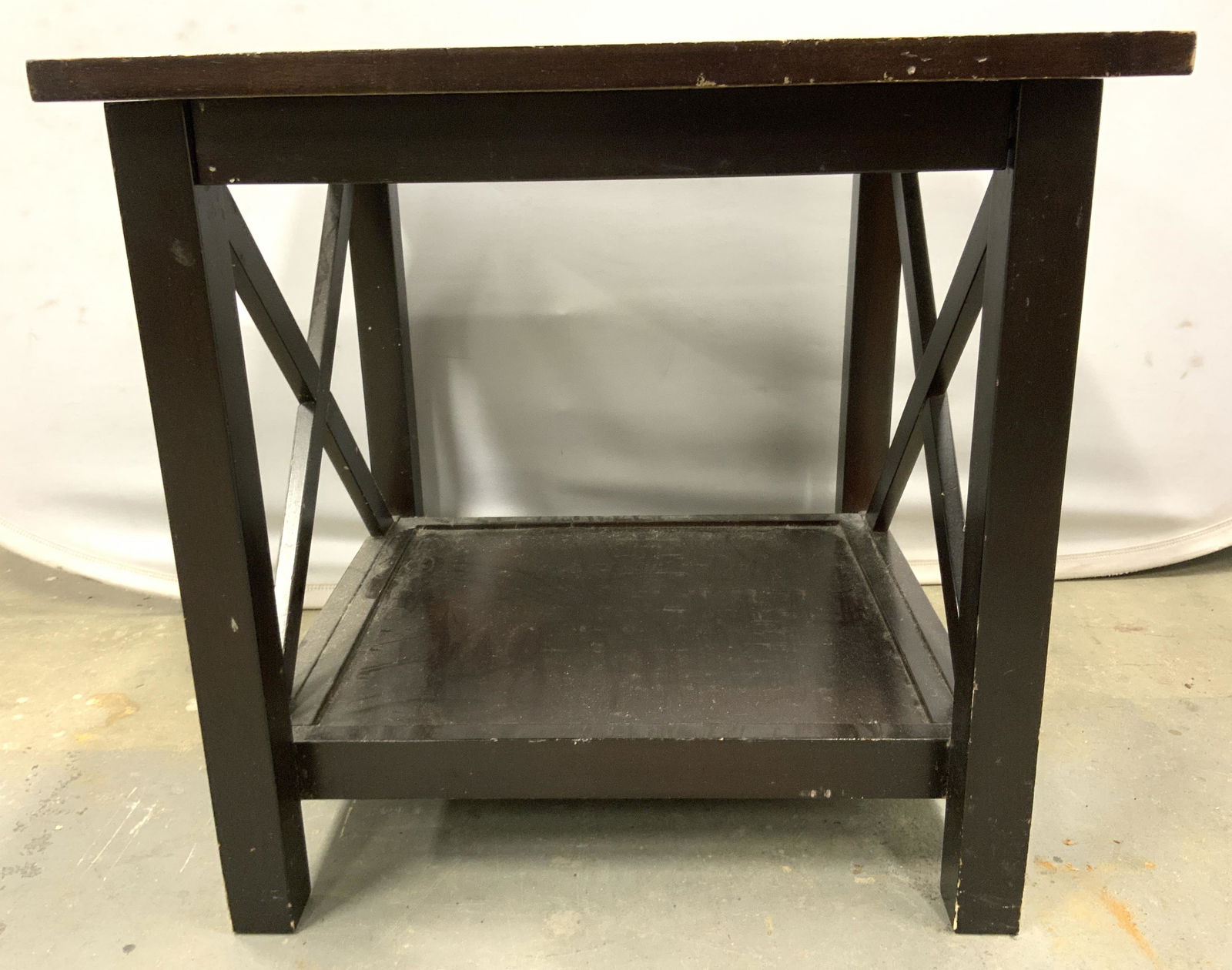 COASTER FINE FURNITURE Wooden Side Table: Underside of tabletop is marked COASTER FINE FURNITURE. Table is brown toned and wooden. Piece ha square shaped top and lower tier leg stretcher area. Sides of table have X shaped structures. Piece me