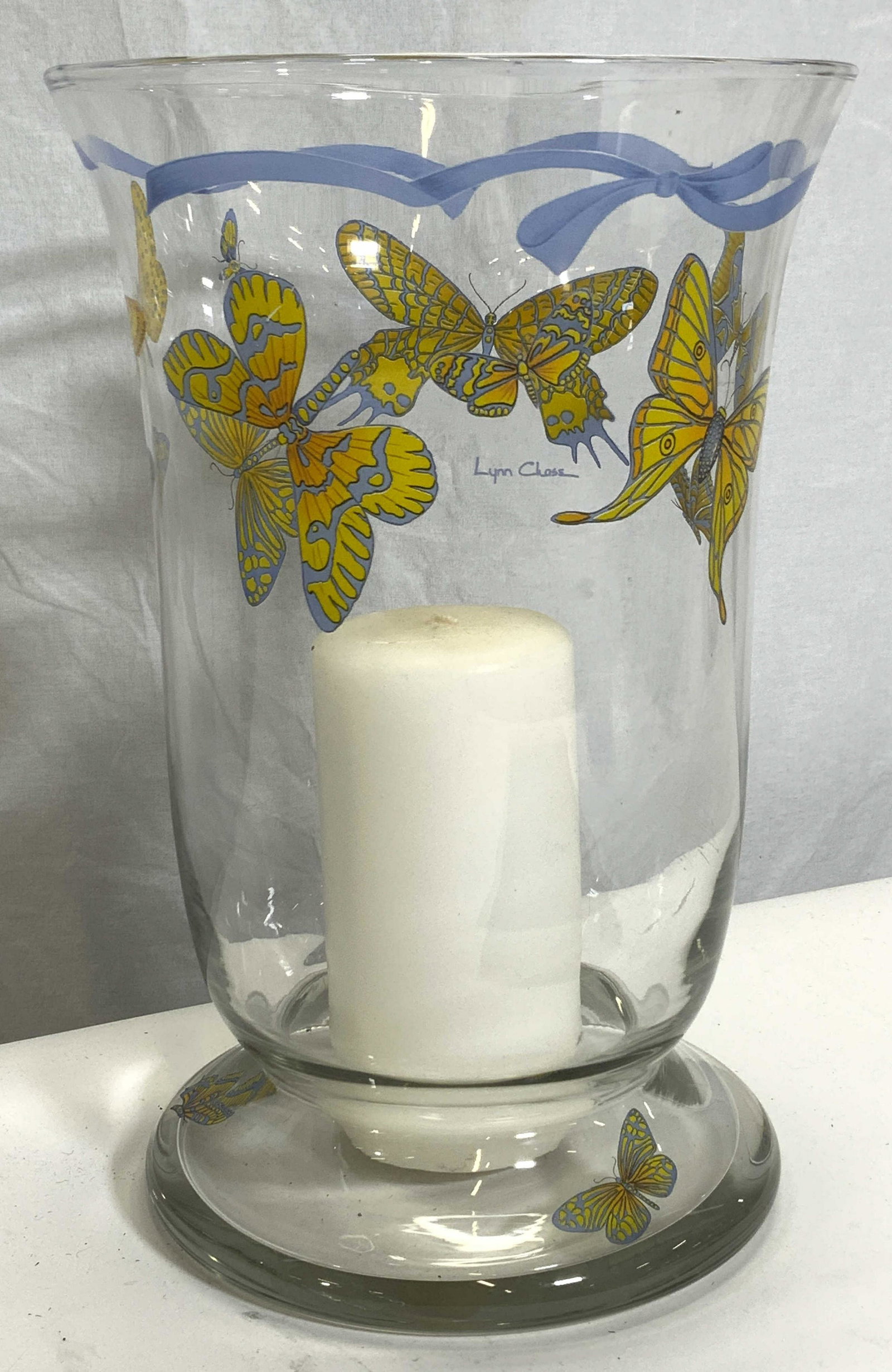 LYNN CHASE Signed & Hand Painted Glass Vessel: LYNN CHASE Signed & Hand Painted Glass Vessel, blue ribbon motif around the lip, blue and yellow Butterfly motif around the upper part of the vessel, signed â€˜Lynn Chaseâ€™, pedestal base wi