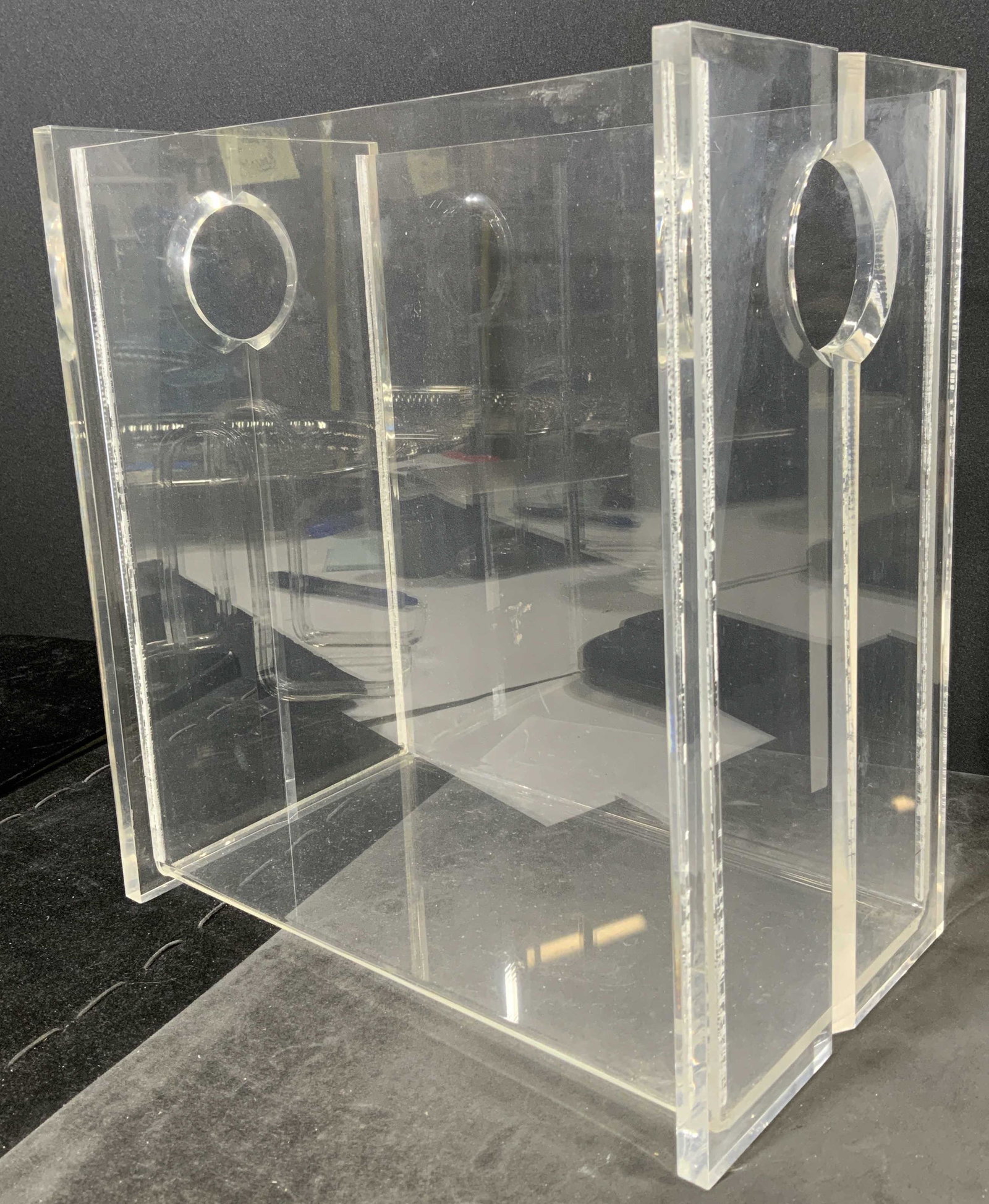 RIALTO Acrylic Bin: Acrylic bin. Beveled detailing decorates two sides of the bin. Sides are pierced. Underside reads as RIALTO PRODUCTS INC, MADE IN TAIWAN. Surface wear and scratches present. Measures approx 11 inches 