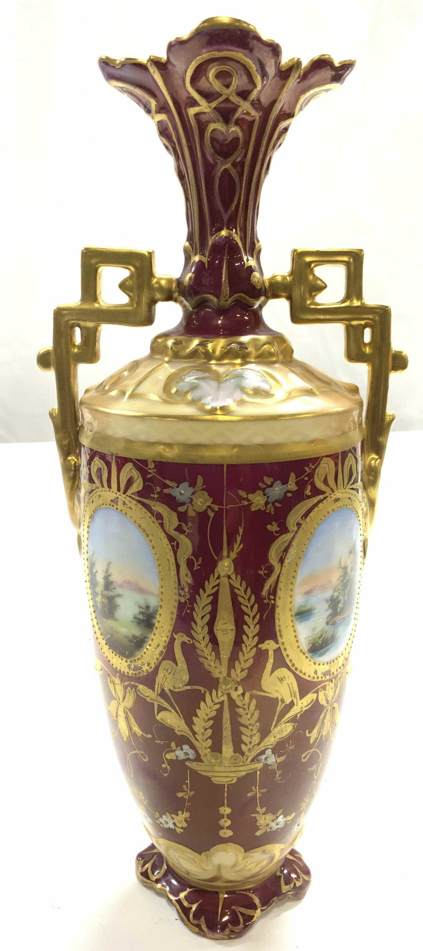 RW RUDOLSTADT GERMANY Porcelain Vase: Underside of vase is marked RW. Vase is is porcelain with intricate gold gilt floral, leaf, bird, & ribbon detail. Vase has 2 geometrically structured handles. Piece also has landscape depictions. Vas