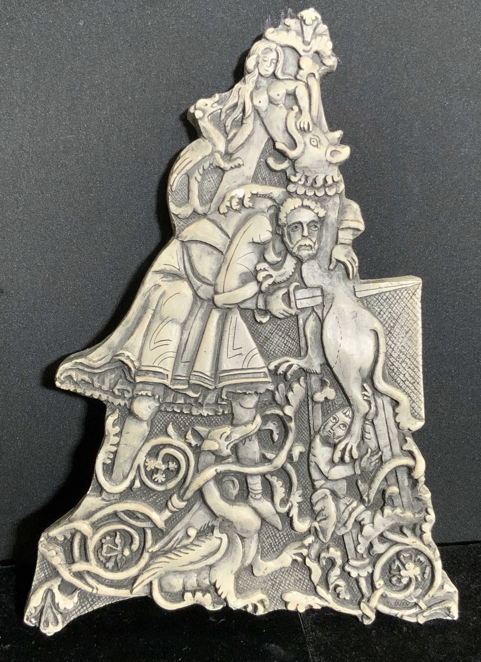 A ROMANESQUE ALPHABET Ceramic Relief: A ceramic relief depicting nude female forms, mythological creatures, man, and foliage. Reverse reads A ROMANESQUE ALPHABET reproductions of original reliefs by Joan S. Diamond. Sticker below taped on