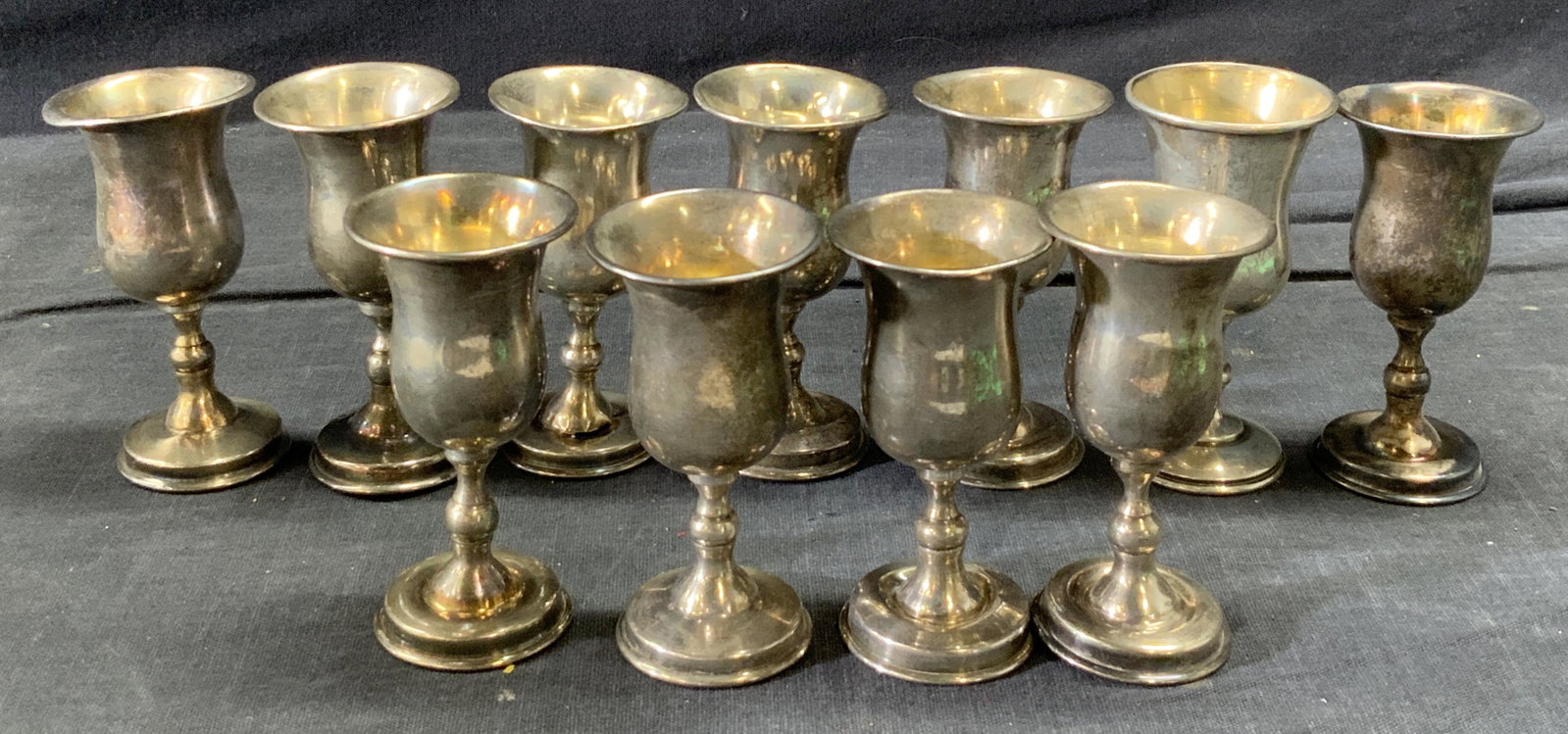 Set of 11 Sterling Cordial Stemware: Set of 11 Sterling Cordial Stemware. Reads Sterling on base rim. Measures approx 2 3/4 in tall by 1 3/8 in in diameter at top. Each individual piece weighs approx .44 ozt. Evident wear, tarnishing, di
