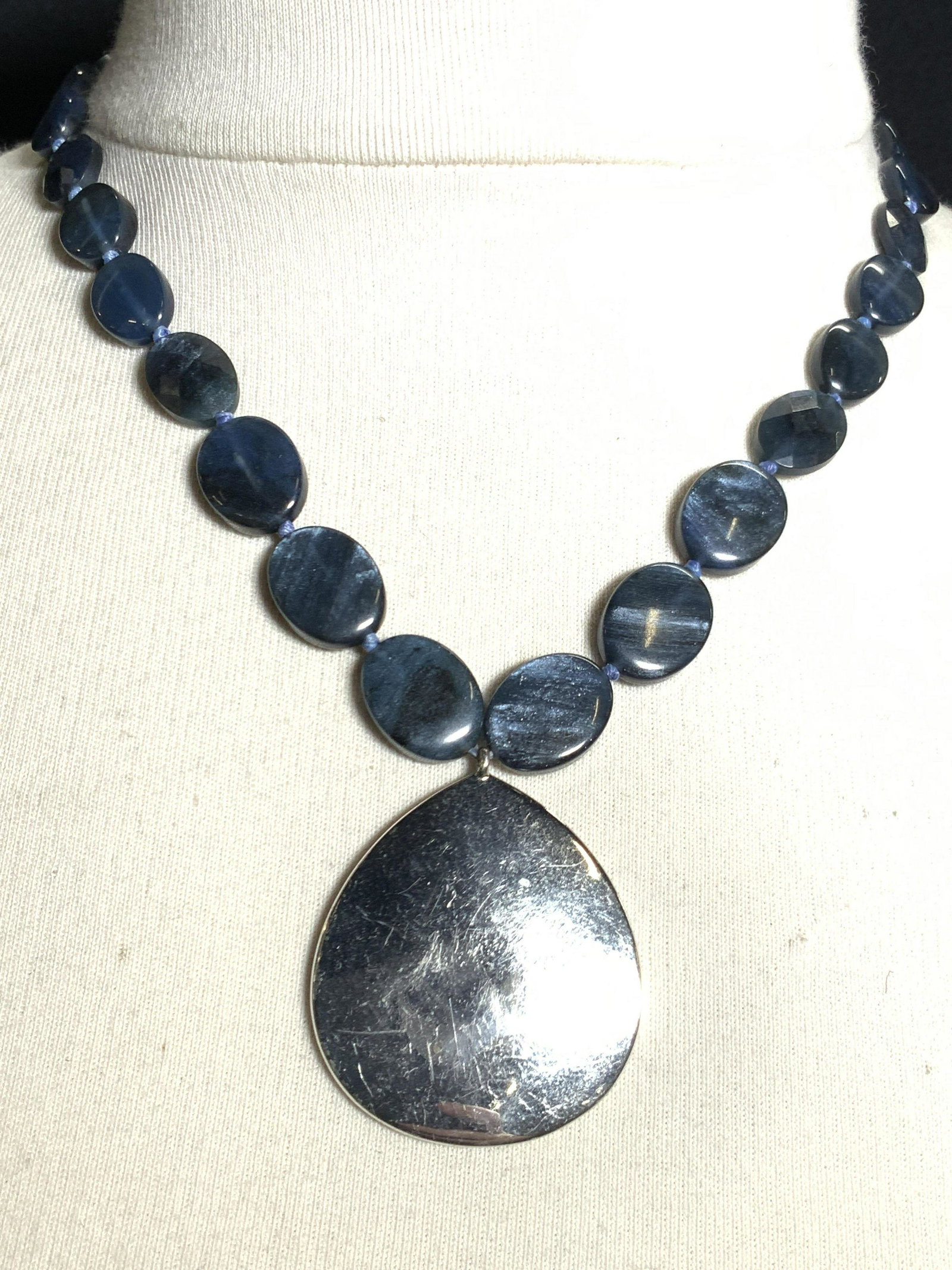 Monet Signed London Blue Style Necklace: Adjustable Necklace with a silver toned tear drop pendent with blue faceted gemstones Marked Monet on clasp charm. Approximately 10 inches long. Monet Necklace, Monet jewelry, Monet accessories. Chunk