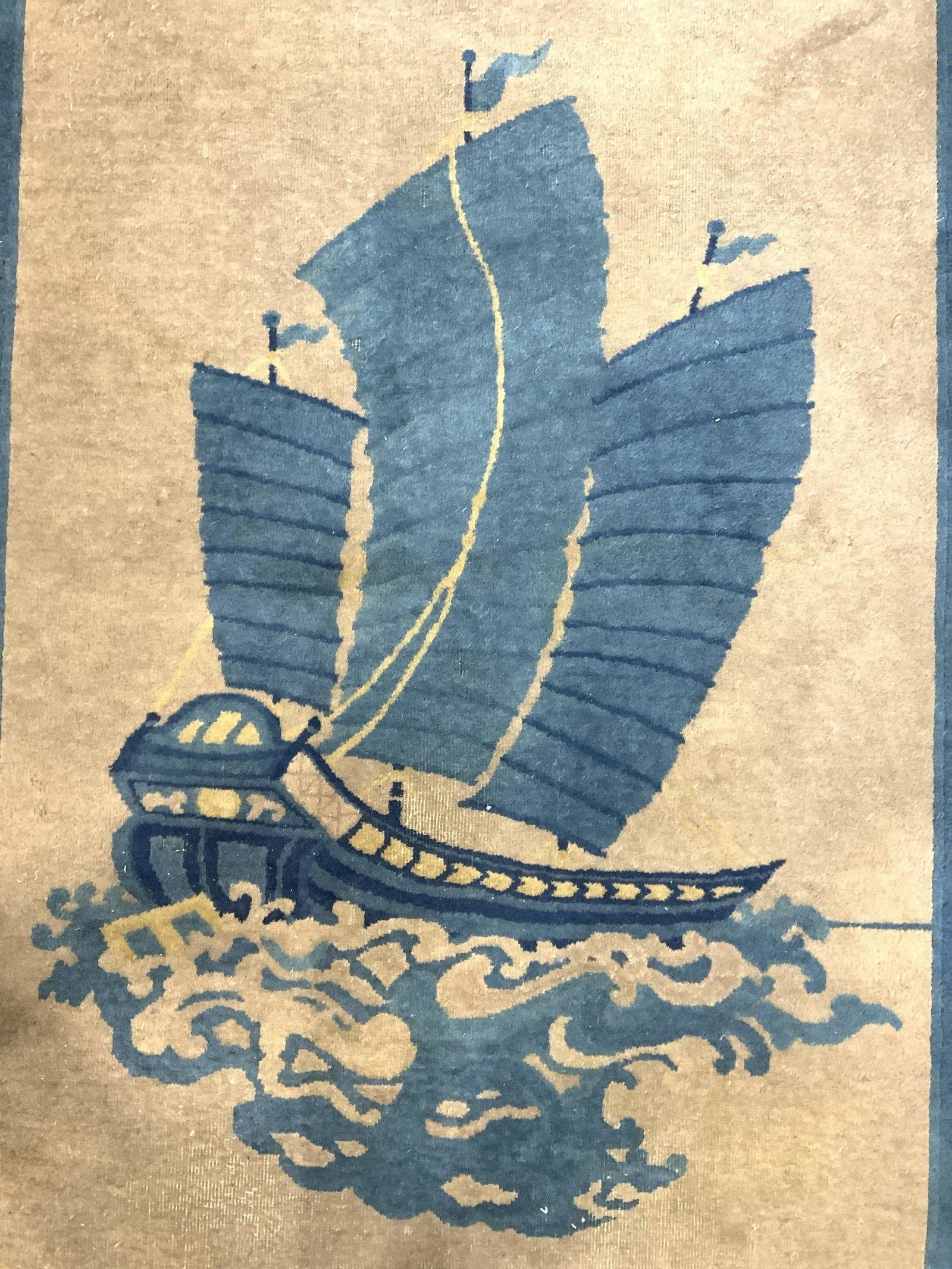 Vintage Handmade Chinese Art Deco Wool Rug: Rug is handmade and wool. Piece is vintage possibly antique. Rug has multi toned detail of ship. Piece also has blue toned borders with sand toned inner area. Rug measures approx 82 inches long 49 inc