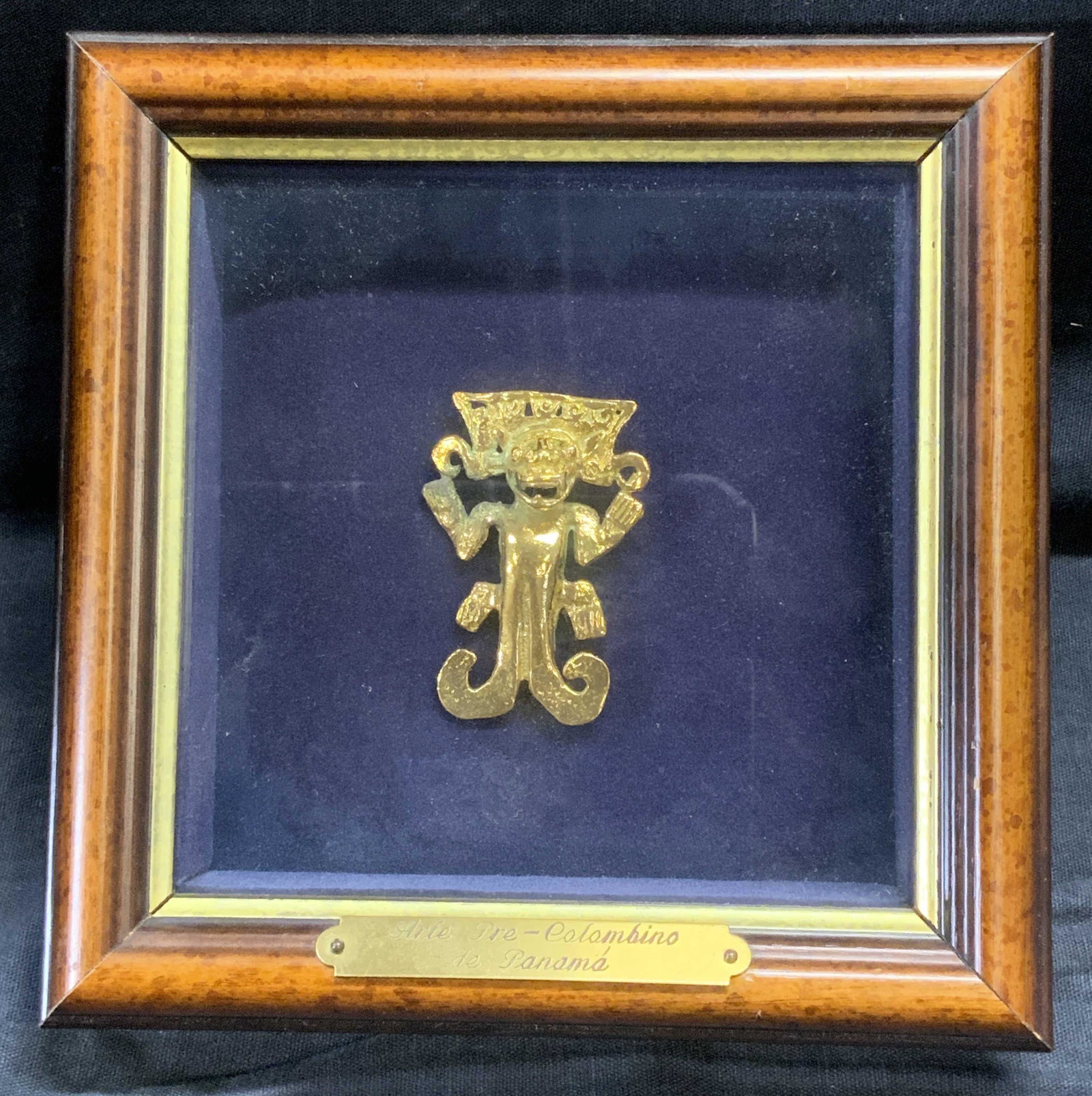 Framed Arte Pre-Colombiano Gilt Metal Brooch: Framed Arte Pre-Colombiano de Panama Gilt Metal Brooch, possibly gilt bronze, plate on frame reads Arte Pre-Colombiano de Panama, shows ancient Central American figure, likely a god or deity, frame me