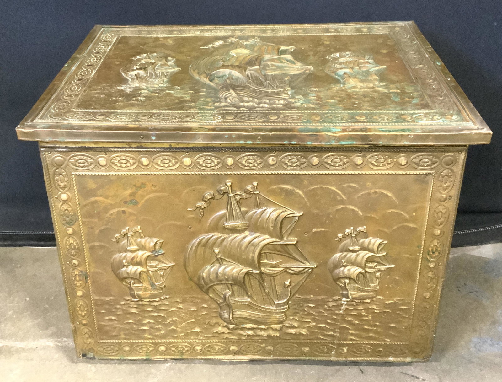Embossed Antique English Wood Kindling Chest: Embossed Antique English Wood Kindling Chest, maritime motif embossed brass plating on wood, some discoloration to brass, measures approx 14 1/2 in. tall, 18 1/2 in. wide, and 11 3/4 in. in dimension.