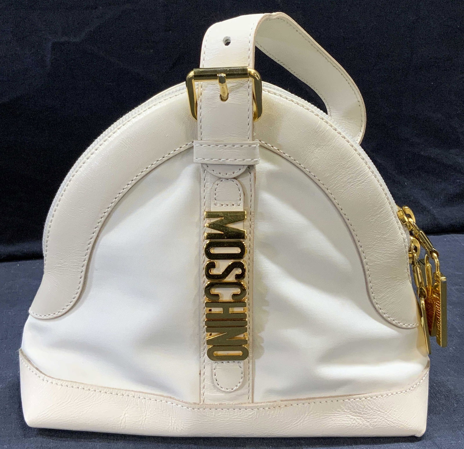 MOSCHINO VNTG White Leather Hand Bag: MOSCHINO VNTG White Leather Hand Bag, measures 8 inches long x 3 inches wide x 7 inches tall, hand drop of 3 1/2 inches tall. Property of Trump Tower Manhattan and Bedford, NY Estates. bags, leather h