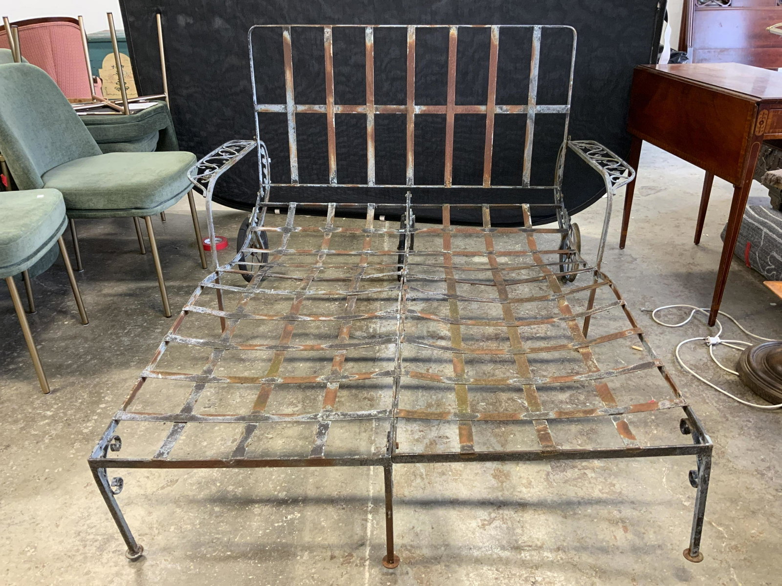 Vintage Outdoor Metal Lounge: Lounge is vintage possibly antique. Piece is slate toned and metal. Armrests have vine and leaf structures Measures approx 76 inches long when fully extended 50 inches wide 22 inches tall. Lounge, met